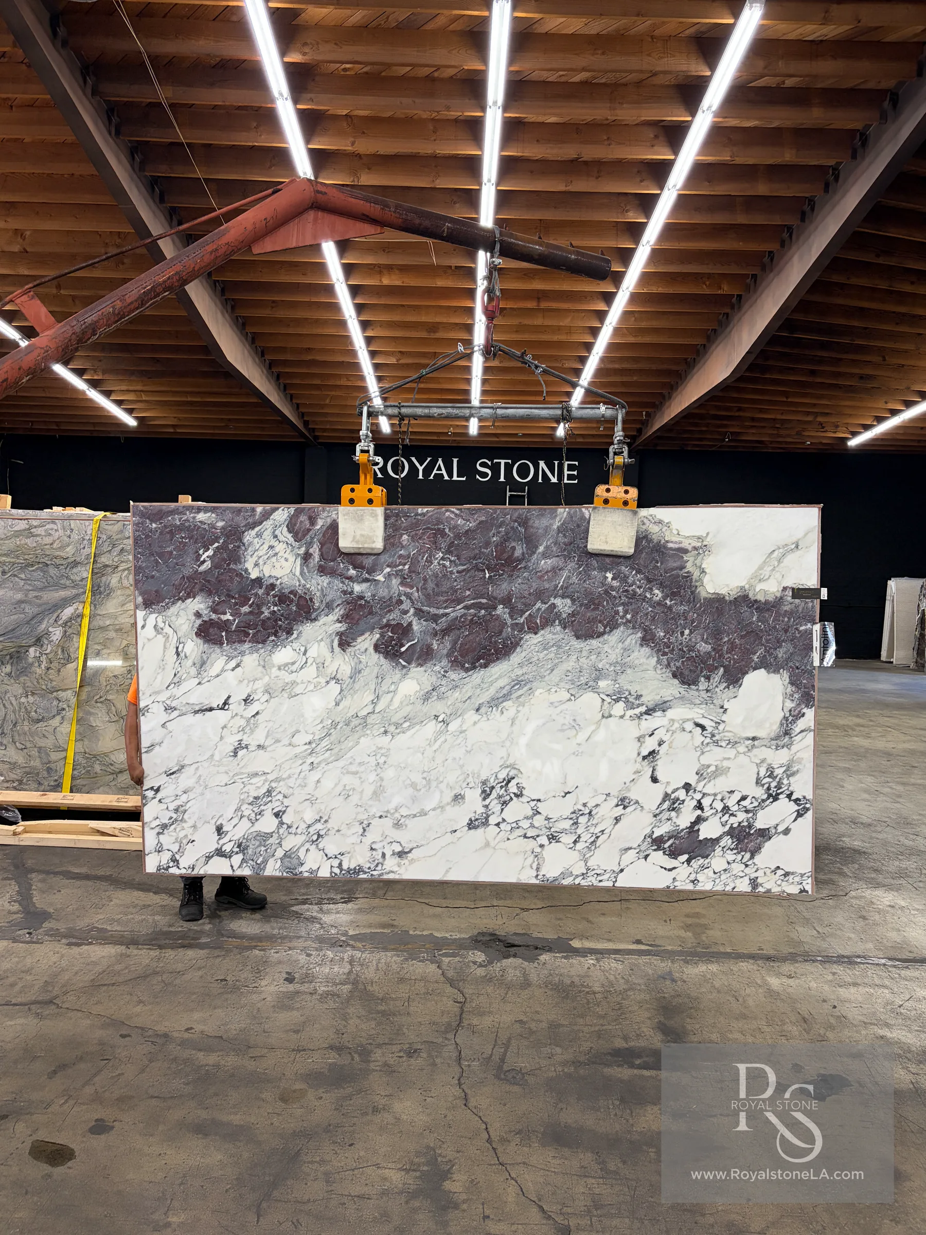 Antolini Breccia Capraia Wow YG954 honed marble slab shown full height in the Royal Stone yard, with deep burgundy and violet breccia over a white and gray field