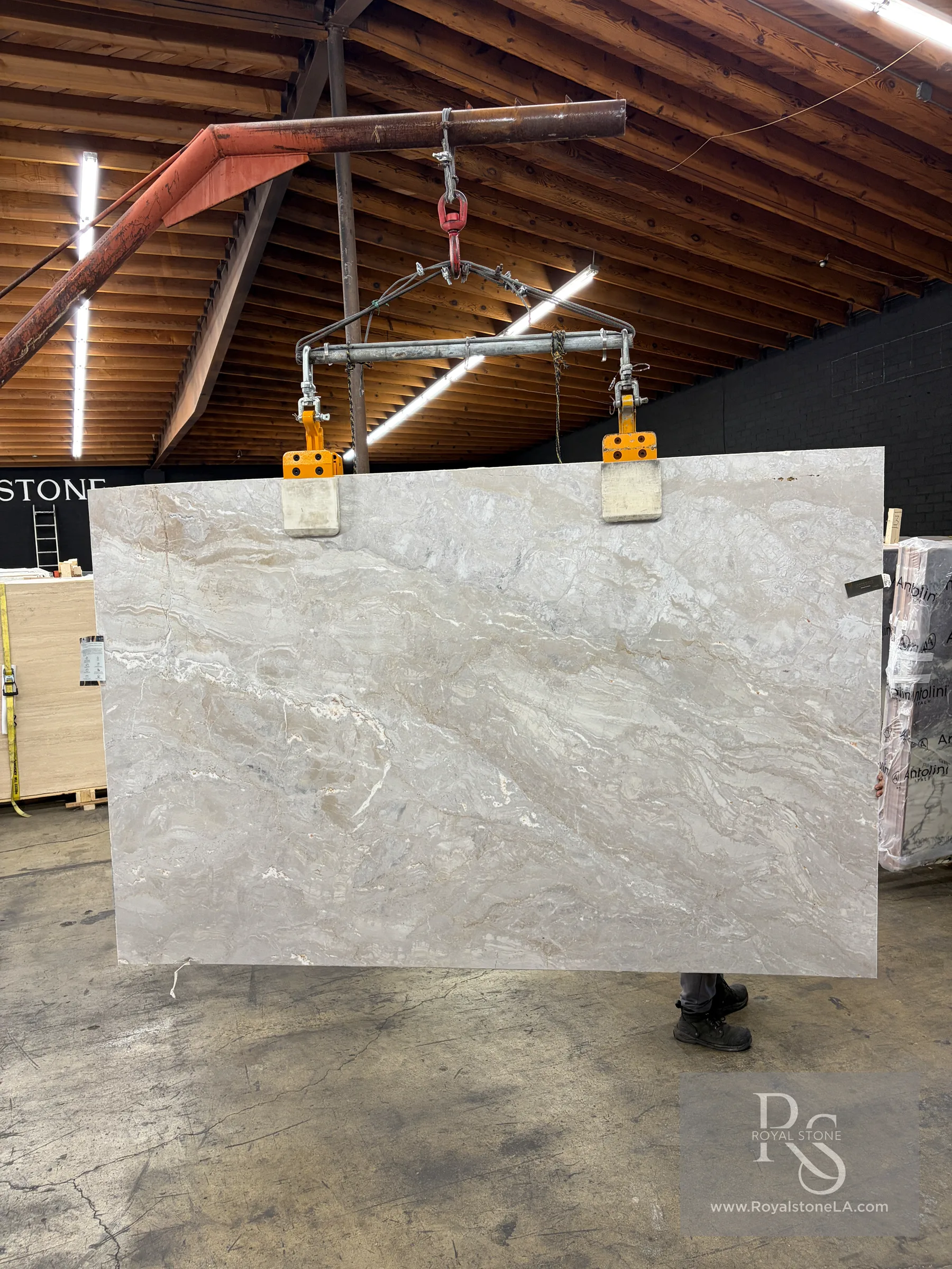 Antolini Dolce Vita EF531 honed marble slab being handled in the Royal Stone warehouse, showing the full 76 by 117 inch slab