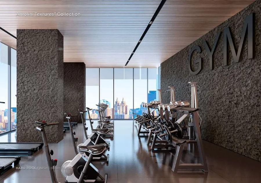 Antolini Basalto Italiano basalt in Hard Rock Finish, dark grey volcanic field with vesicle pattern, commercial gym install