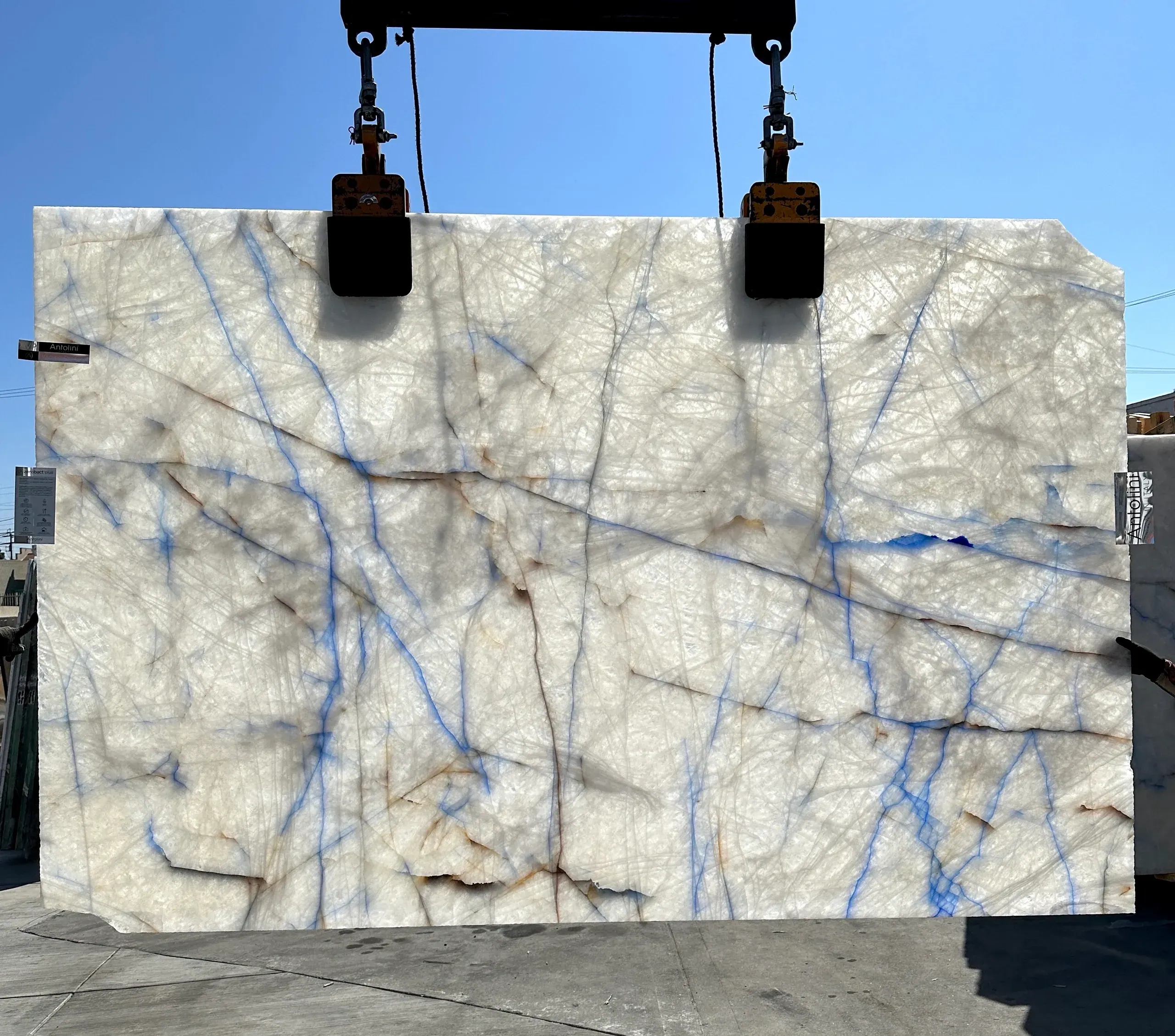 Backlit Antolini Cristallo Quartzite displaying luminous crystalline patterns and blue veining