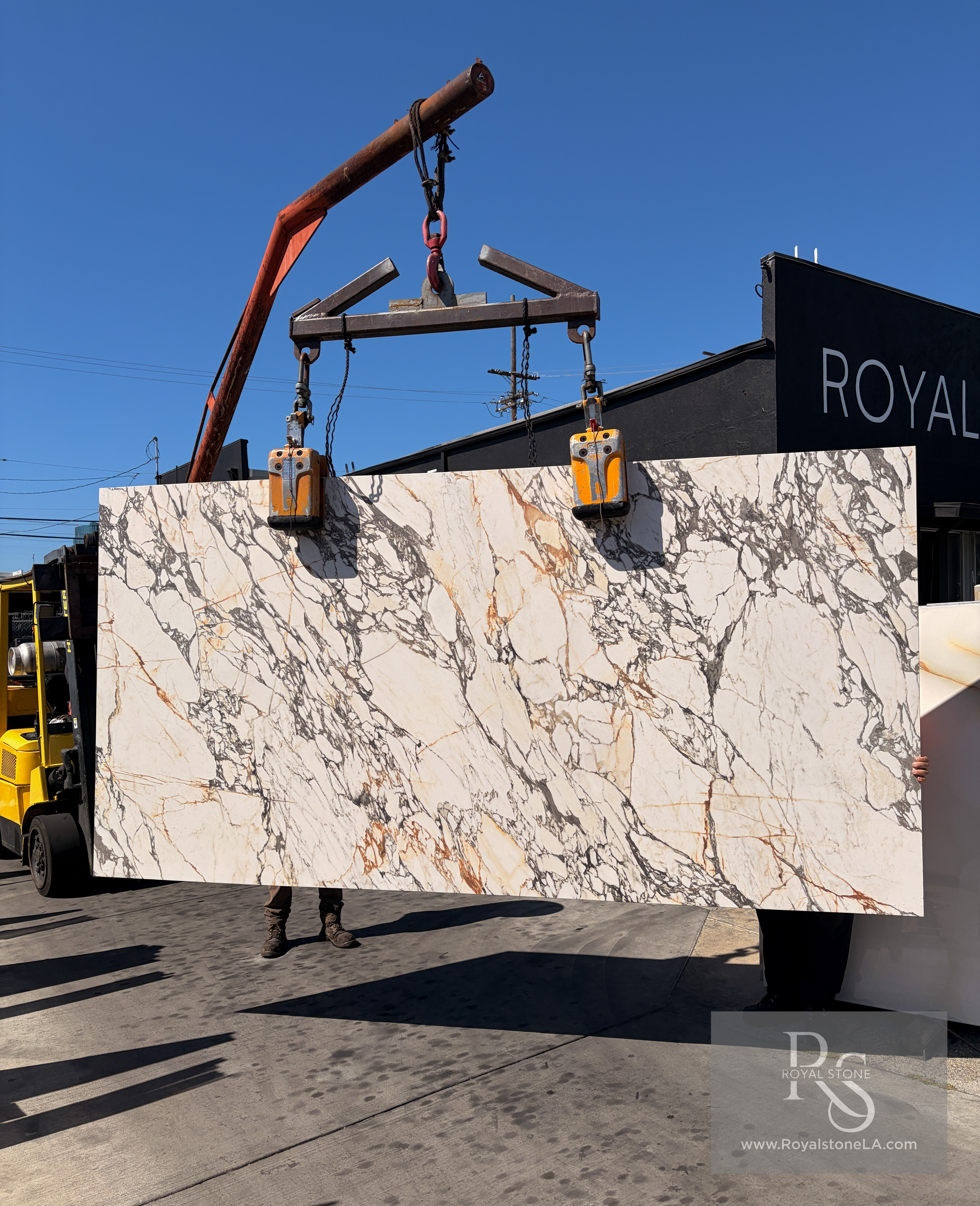 1.2cm ABK Corchia Gold honed porcelain slab, 63 by 126 inches, being unloaded at the Royal Stone yard after arriving from Italy