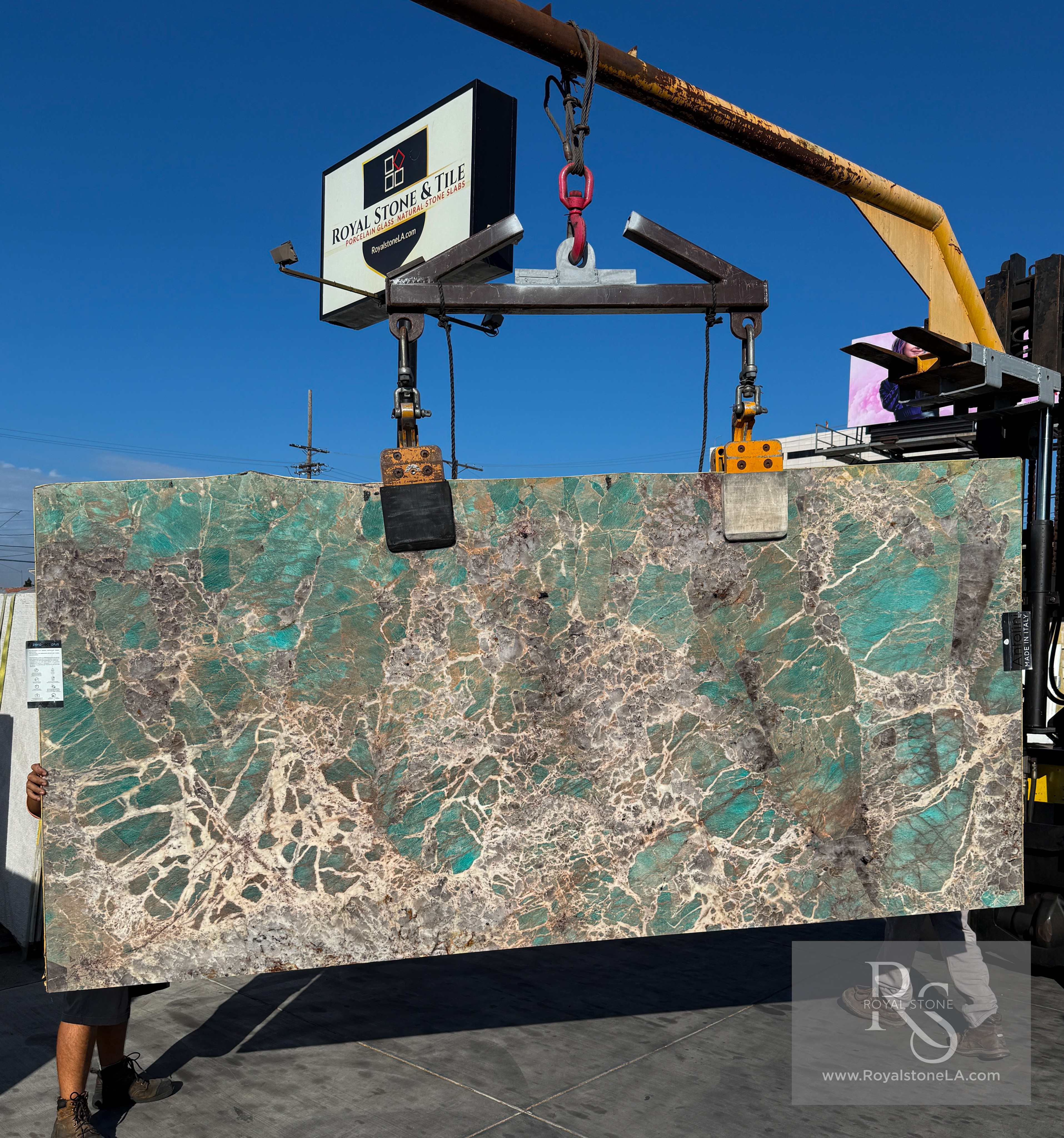 Antolini Amazonite Precious Stone Extra quartzite slab on the crane, deep turquoise field with white crystal veining and smoky inclusions, polished finish