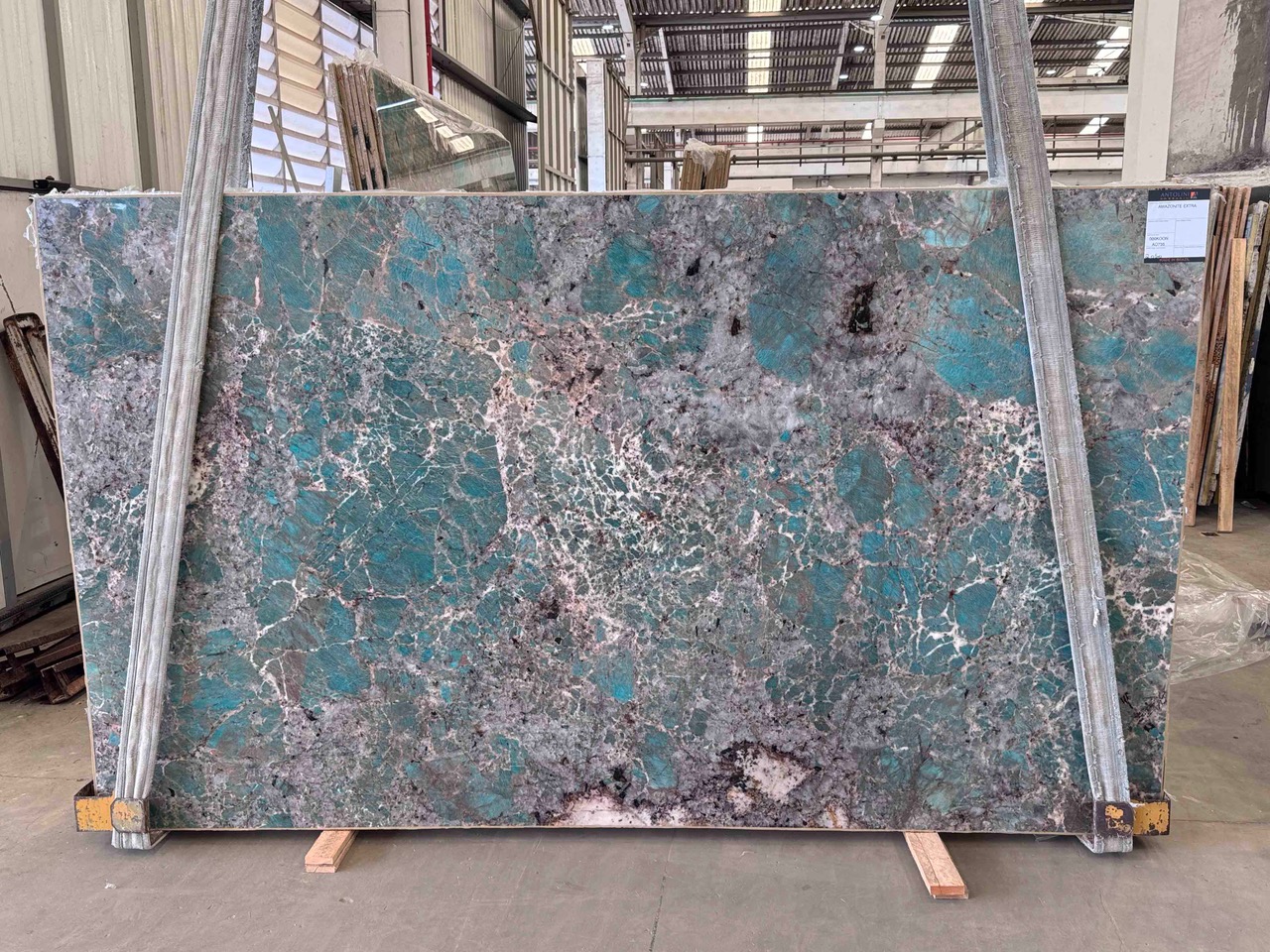 Antolini Amazonite Extra quartzite slab with saturated turquoise field and grey-violet crystal net, polished finish