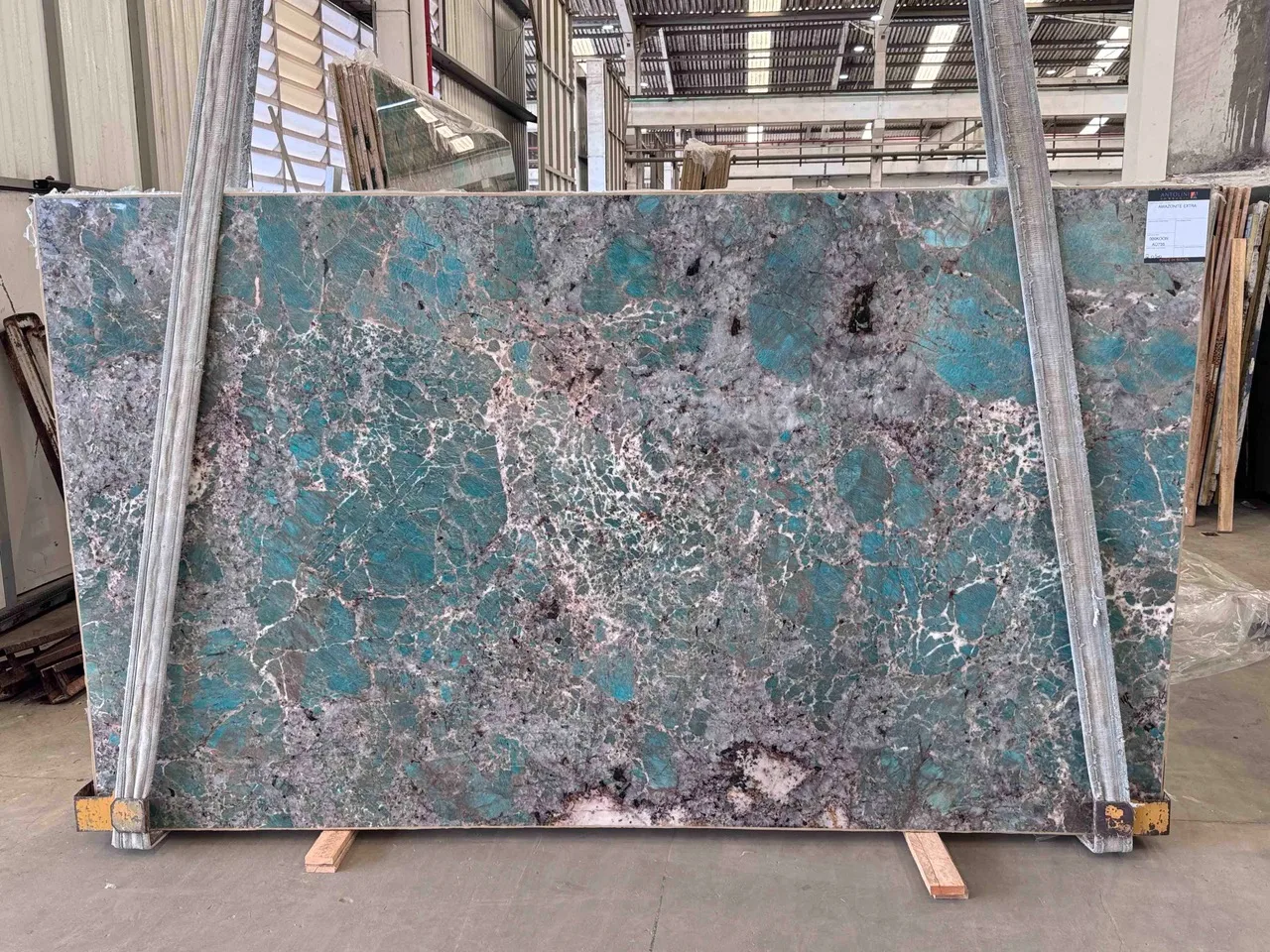 Antolini Amazonite Extra quartzite slab with saturated turquoise field and grey-violet crystal net, polished finish