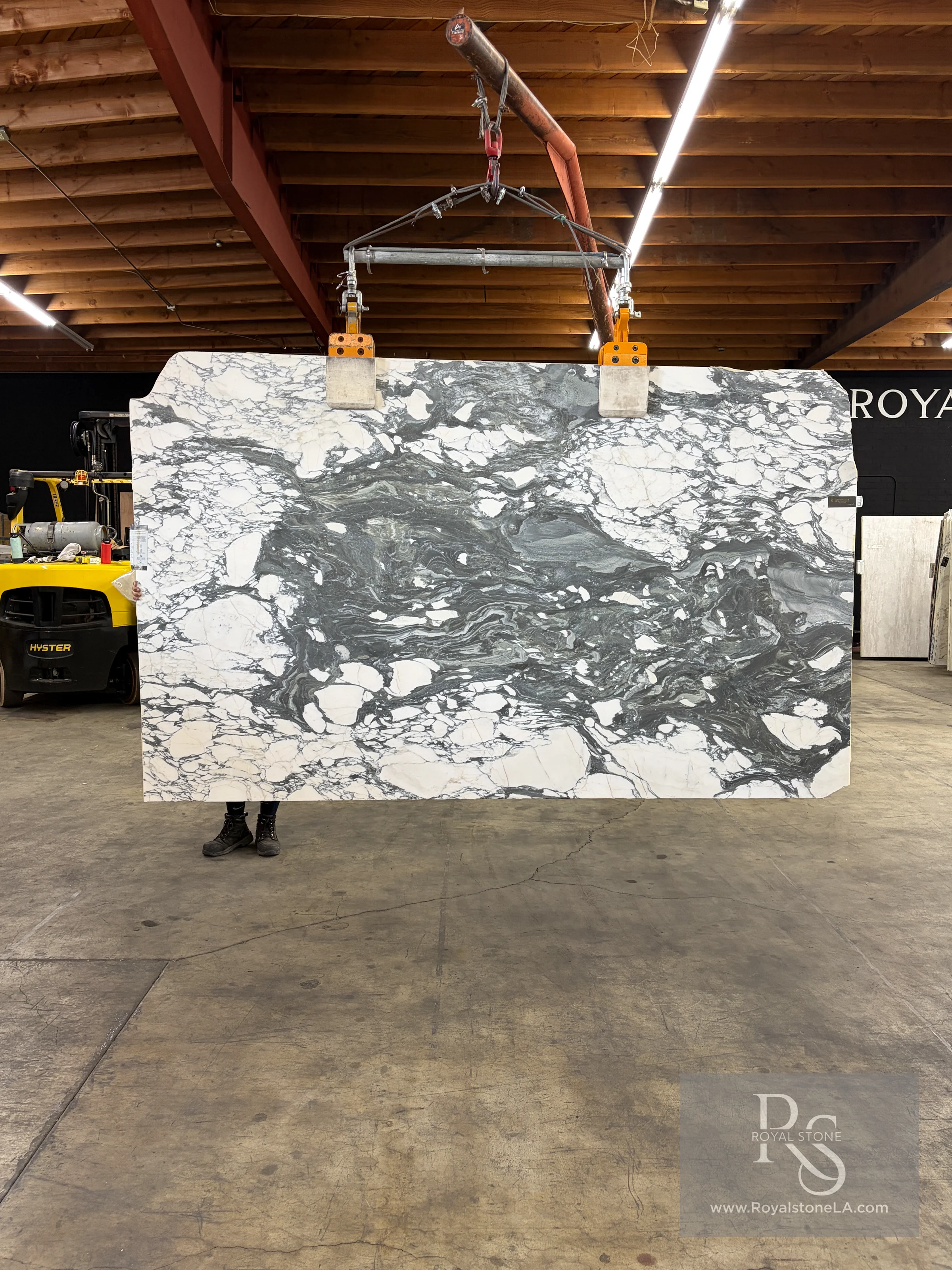 2cm Antolini Arabescato Corchia Extra EC798 honed marble slab, 77 by 122 inches, suspended in the Royal Stone warehouse with a bright white ground and charcoal-gray movement