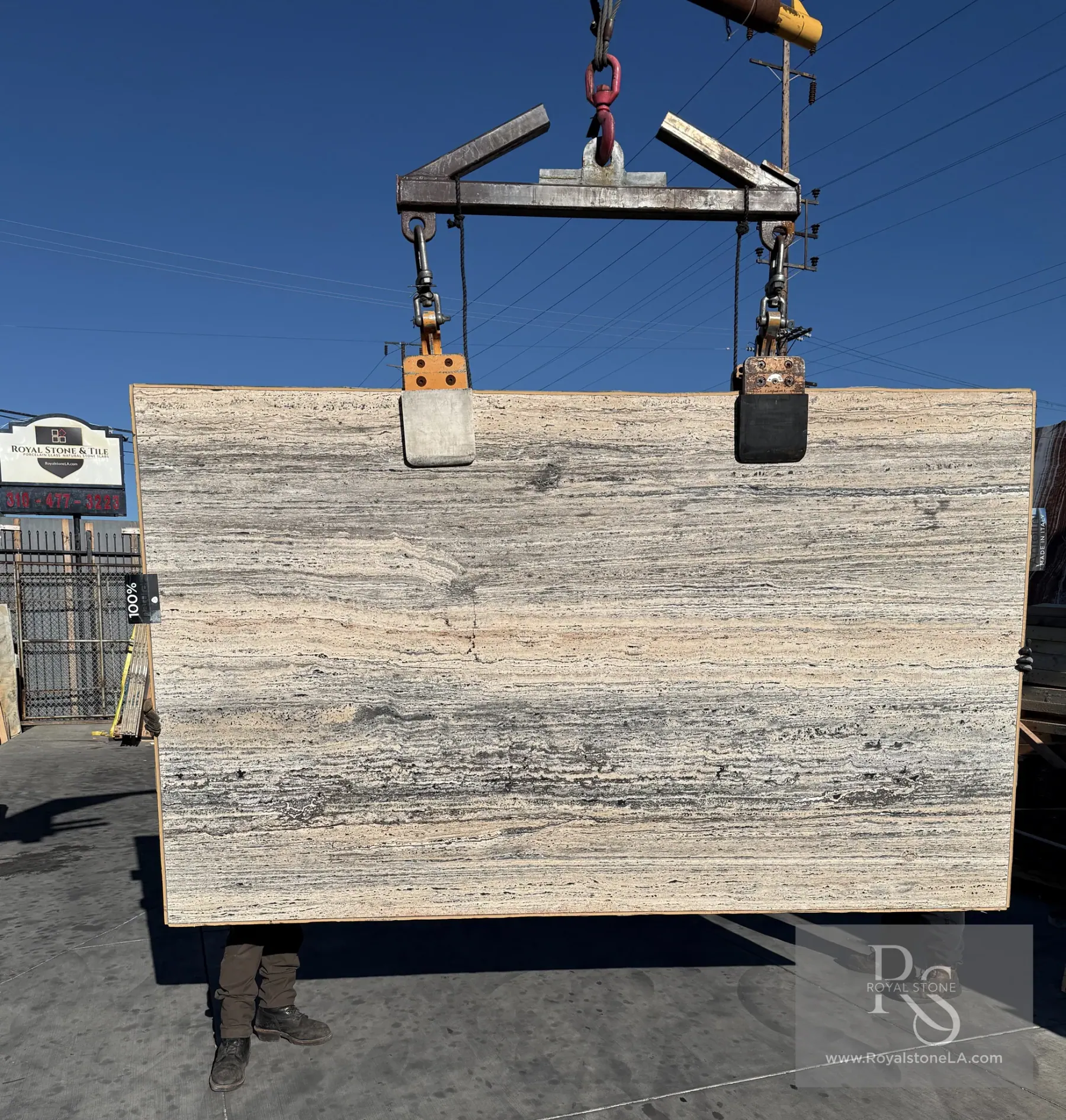 2cm Antolini Black Label Platinum Travertine slab vein cut and leathered at Royal Stone Los Angeles, horizontal silver-grey and warm bone stratification with charcoal seams, 66 by 110 inches