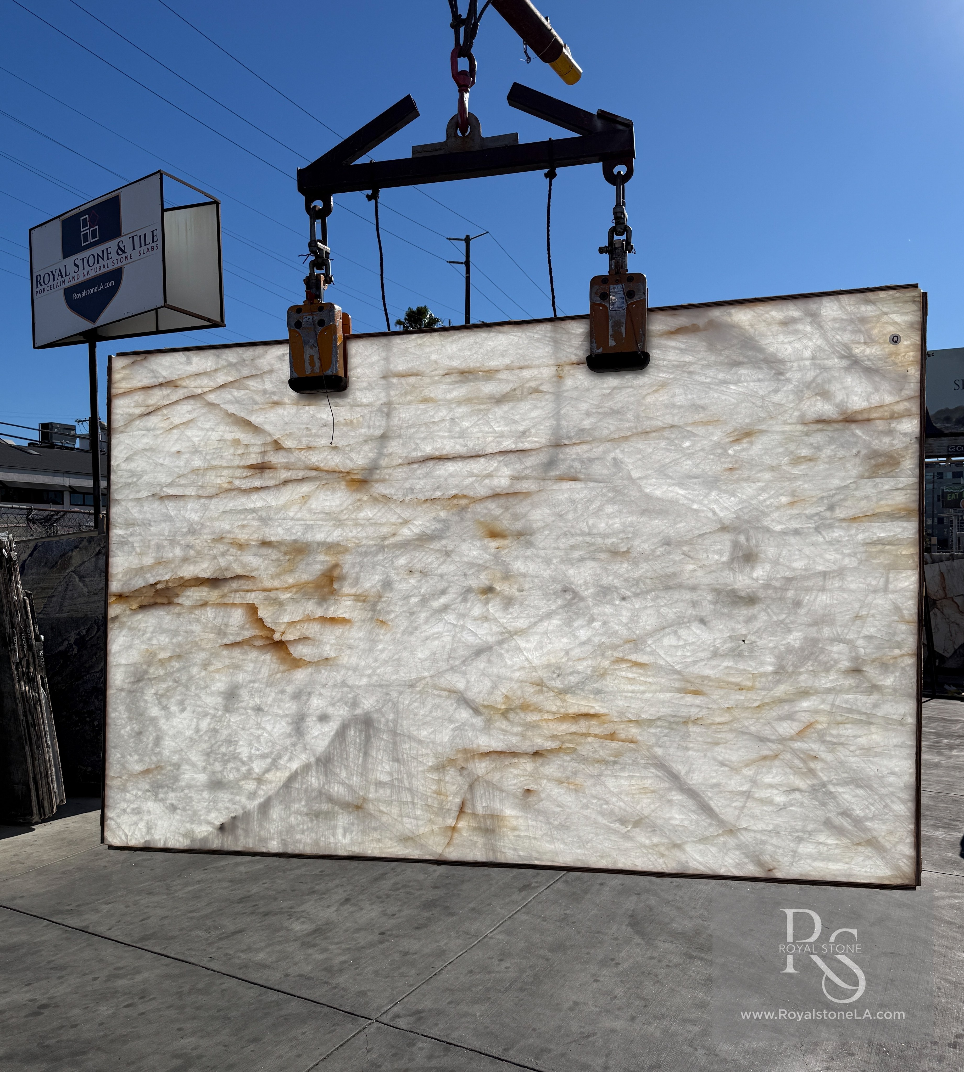 Antolini Cristallo Bianco Lumix A0375 polished quartzite slab backlit, amber veins glowing through the translucent white field