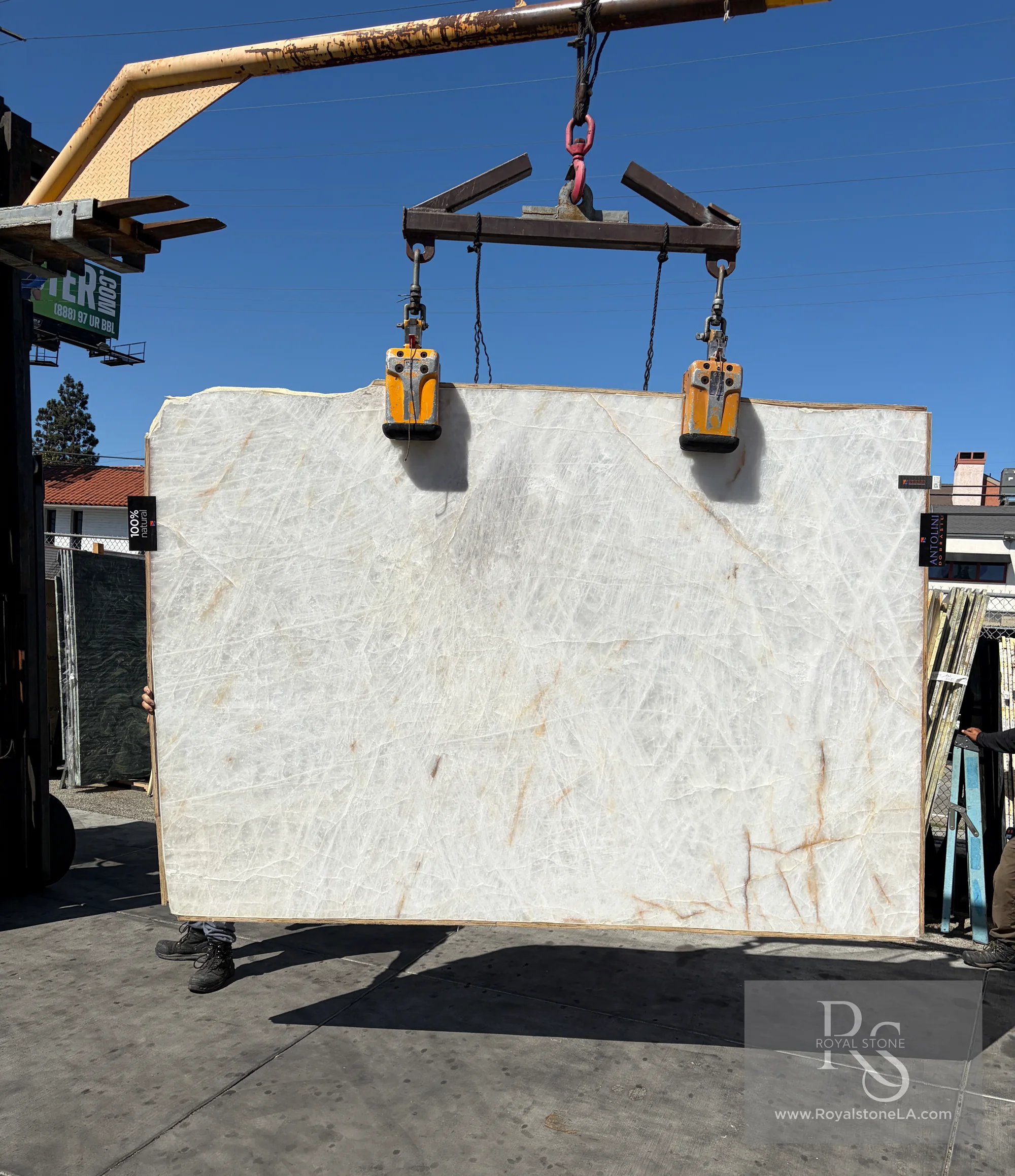 Antolini Cristallo Bianco Lux honed quartzite slab, 75 by 111 inches, shown in standard light with a crystalline white field, warm amber movement, and graphite veining