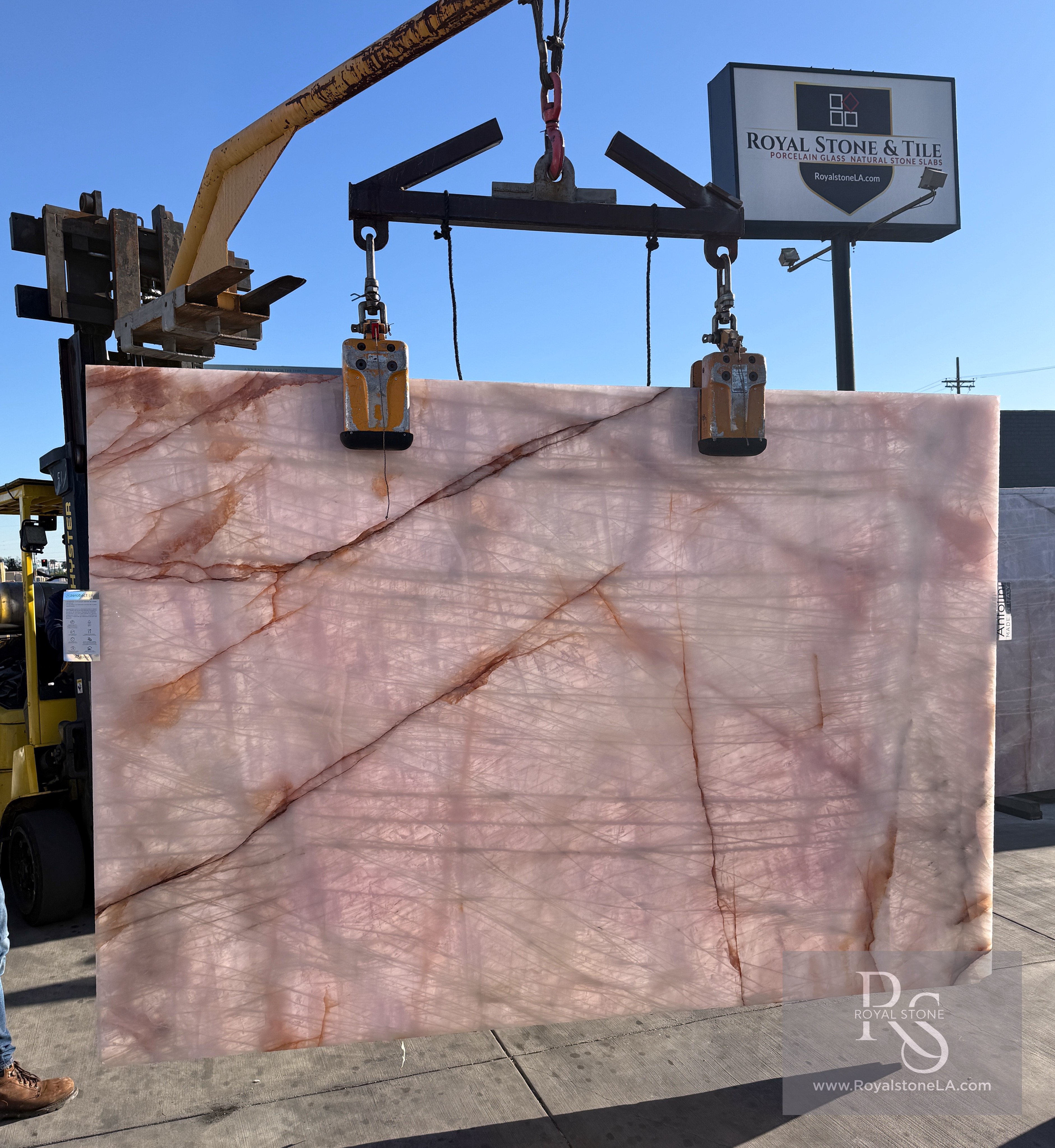 Antolini Cristallo Rosa pink quartzite slab backlit, copper veins glowing through the translucent blush field