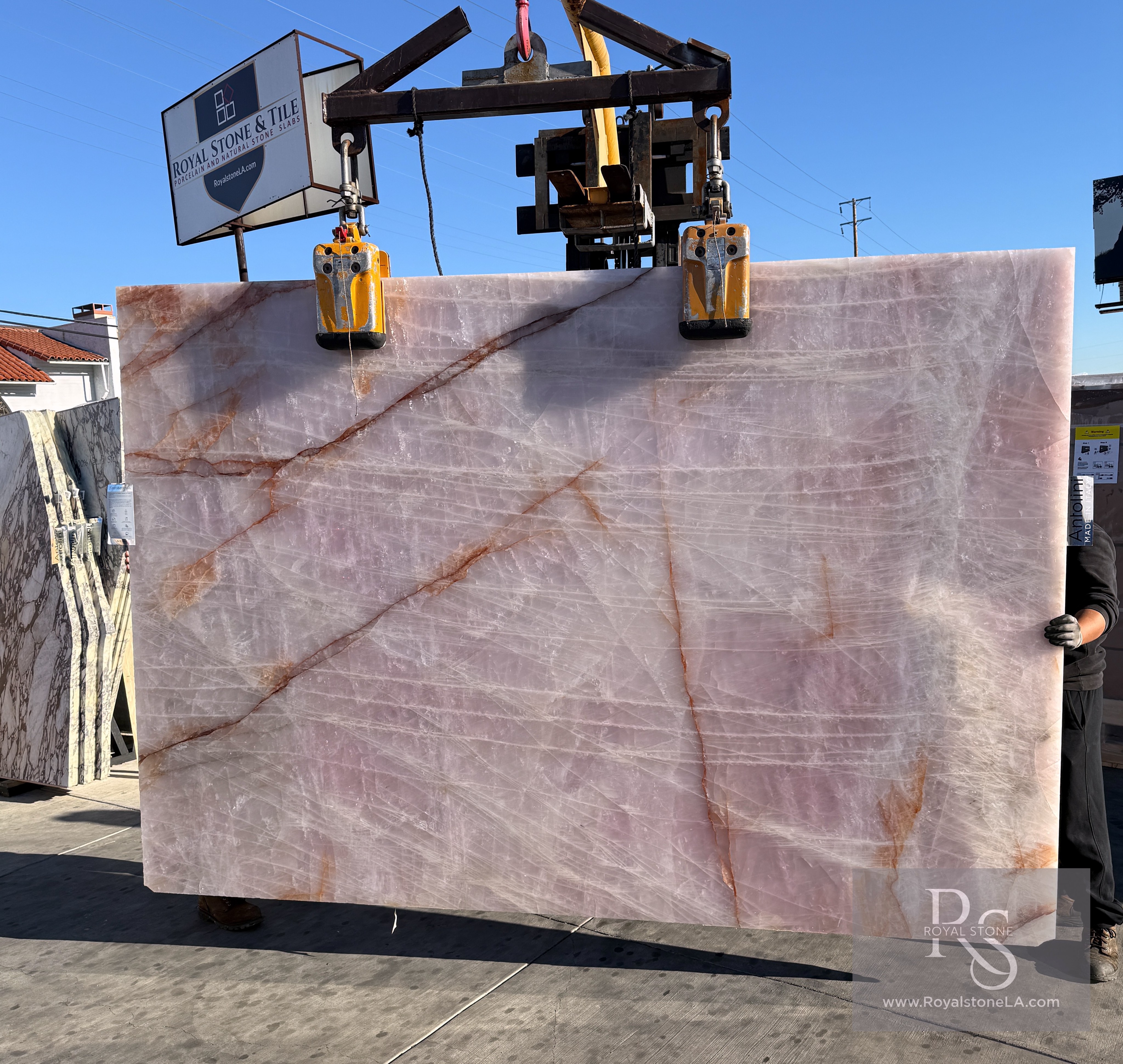 Antolini Cristallo Rosa pink quartzite slab at Royal Stone, blush field with copper-orange ribbon veining