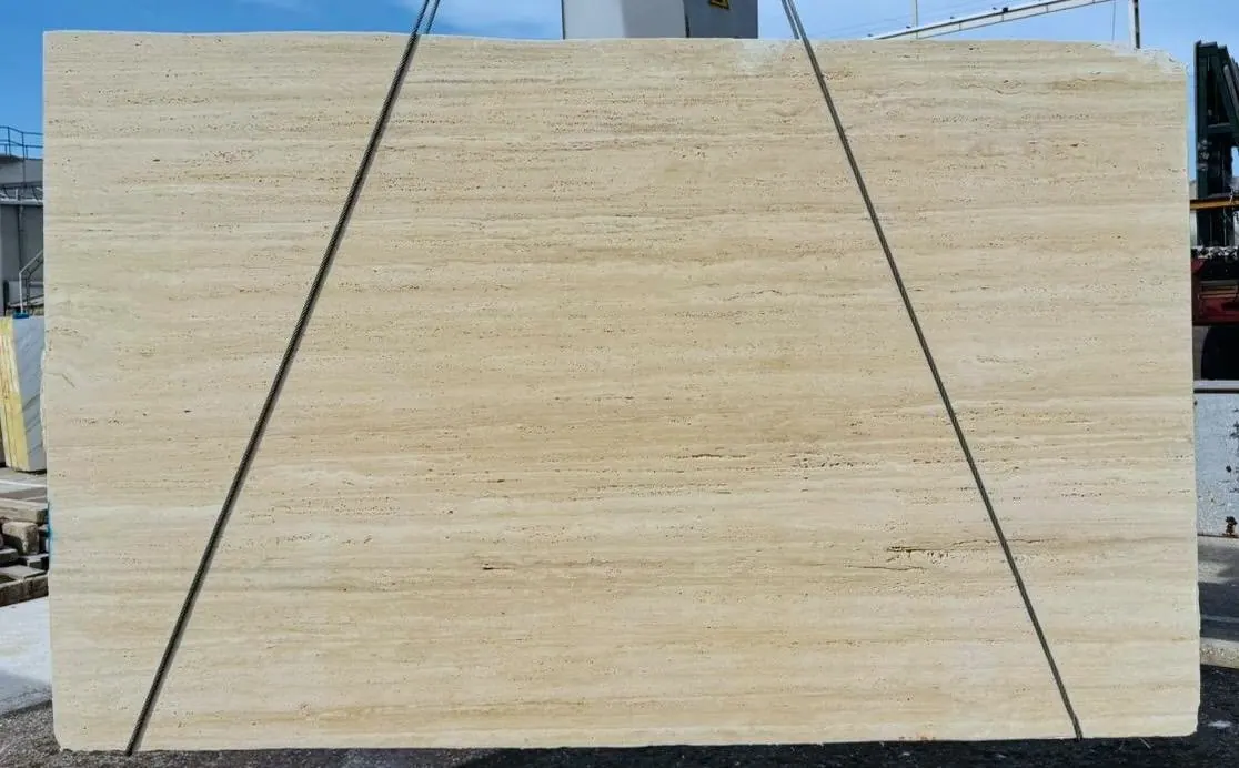 Antolini Ivory Petris travertine slab, vein cut, unfilled, in warm ivory with fine linear banding