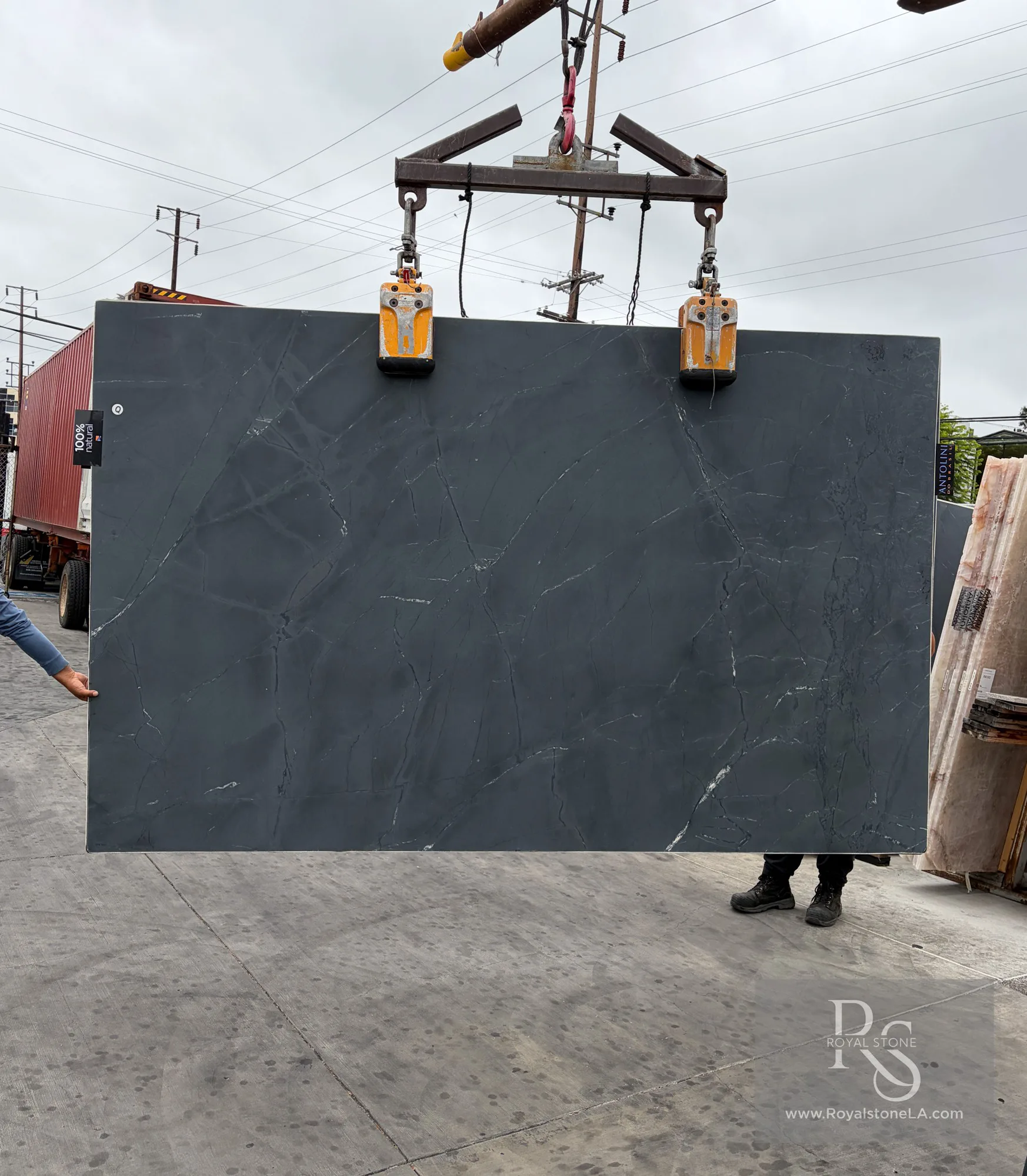 Antolini Negresco quartzite slab, 2cm honed, 78 by 124 inches, with deep charcoal-graphite field and fine white quartz veining, propped on pallets at the Royal Stone Los Angeles yard