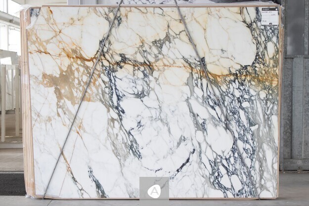Antolini Paonazzo Antico marble slab with white field, charcoal veining, and warm gold-rust accents, polished finish