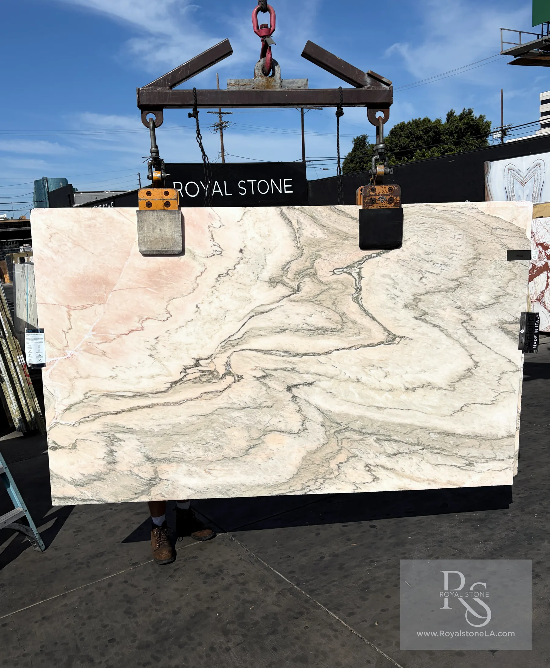 2cm Antolini Pink Paonazzo Rose DX076 honed marble slab, 60 by 98 inches, with a warm cream field, soft pink wash, gray-green veining, and Royal Stone yard crane