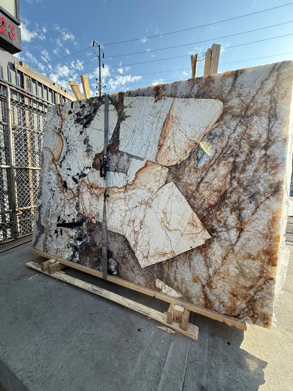 Antolini Patagonia Original quartzite slab in Hard Rock finish at Royal Stone Los Angeles, deep sculpted surface relief across ivory and amber field