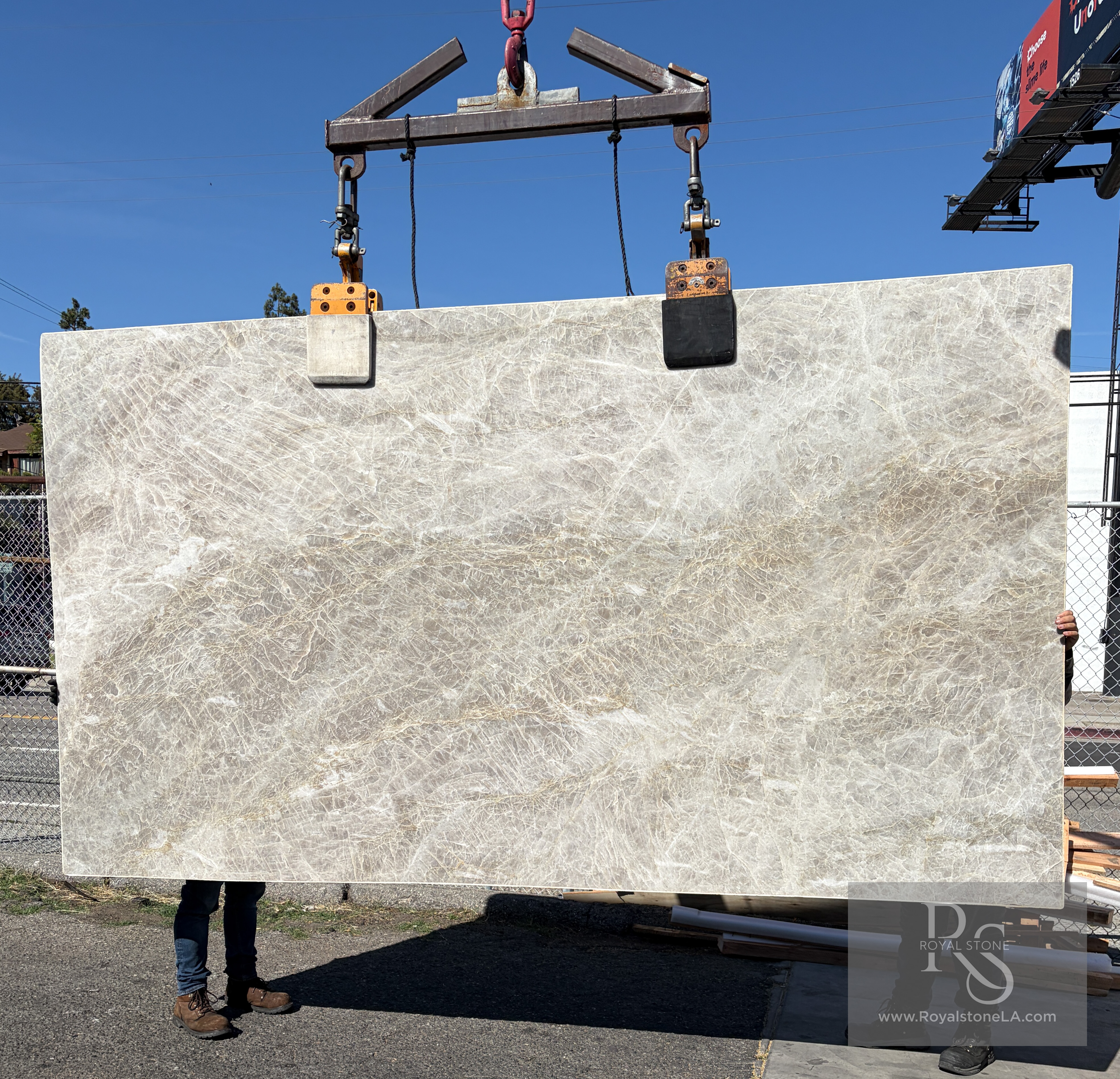 Antolini Taj Mahal quartzite lot AO999 lifted on the crane in the Royal Stone yard, honed finish, soft champagne field with crystalline veining, 74 by 131 inches