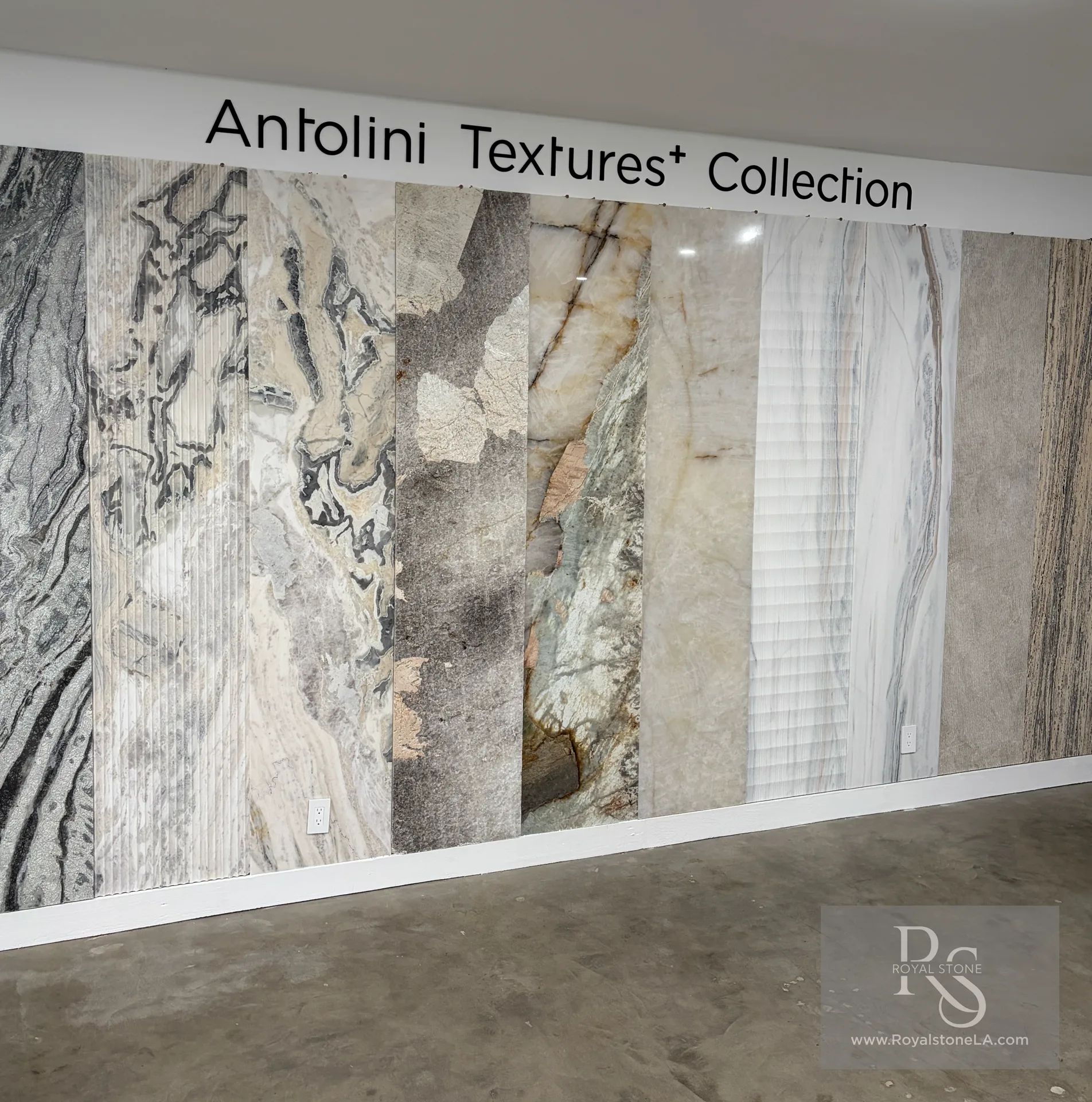 Antolini Textures+ Collection displayed at Royal Stone in Los Angeles, showing natural stone slabs with sculpted and linear surface finishes