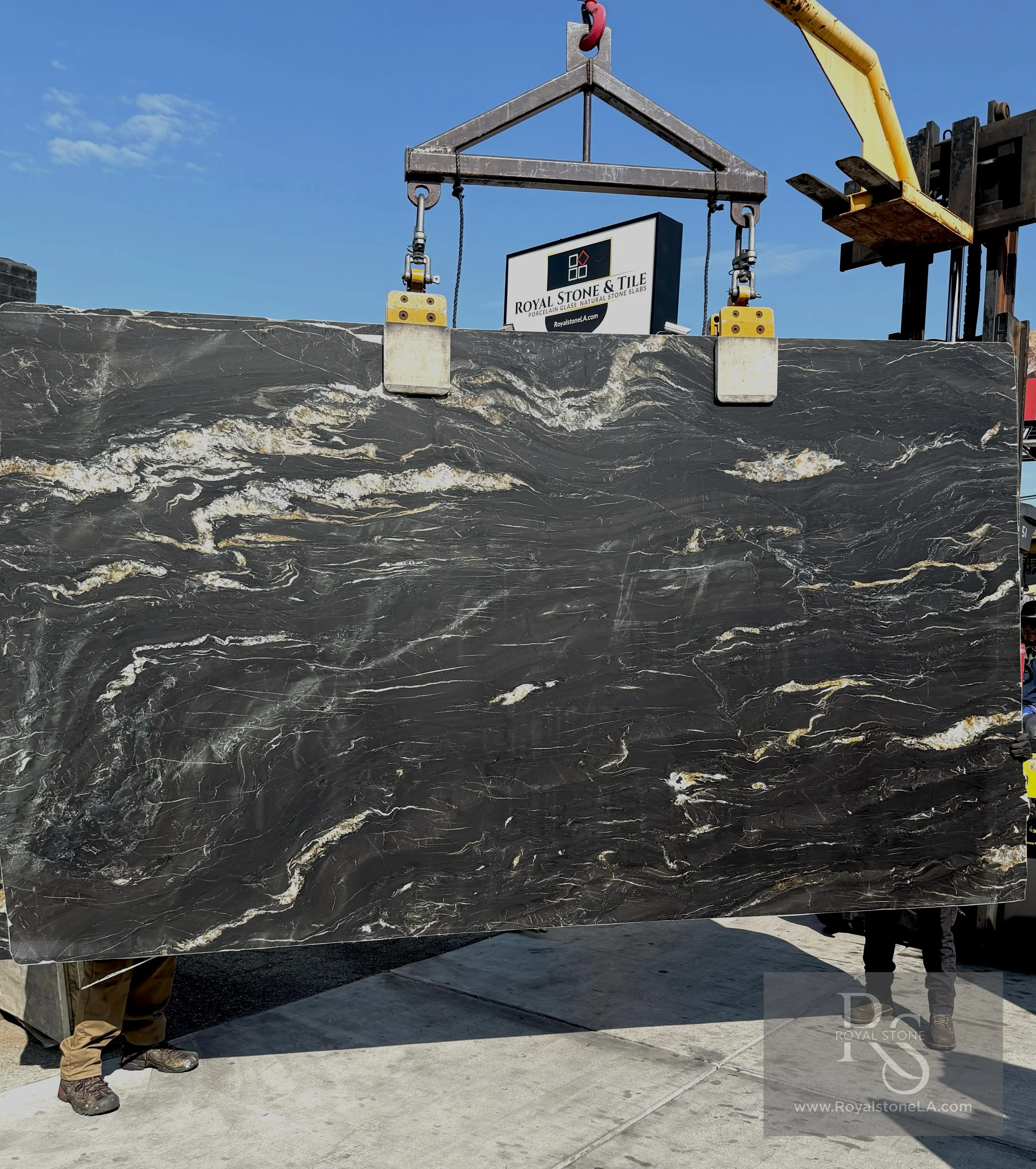 Bonotti Belvedere Titanium Gold quartzite slab in a leathered finish, deep graphite field with warm gold and ivory veining
