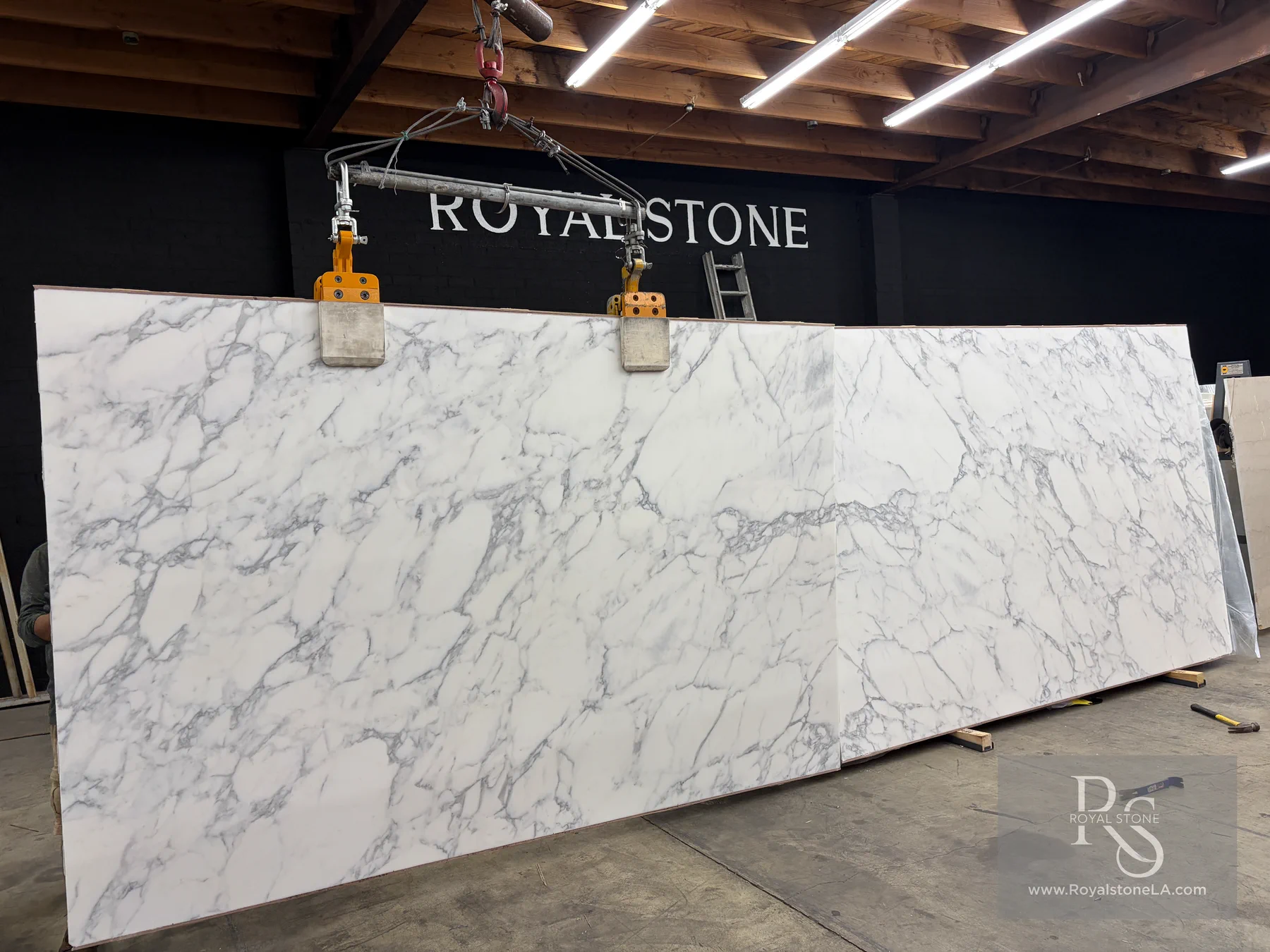 Additional view of a bookmatched pair of 2cm Calacatta Borghini Extra Lot 15728 honed marble slabs inside the Royal Stone warehouse in Los Angeles