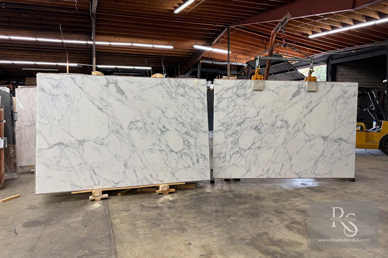 Bookmatched pair of 2cm Calacatta Borghini Extra Lot 15728 honed marble slabs, 78 by 120 inches, stood open in the Royal Stone yard in Los Angeles