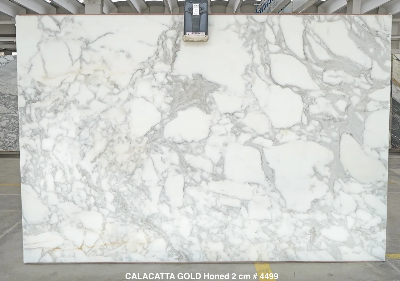 Calacatta Gold Borghini Extra marble slab with white field, soft grey veining and warm gold accents, honed finish