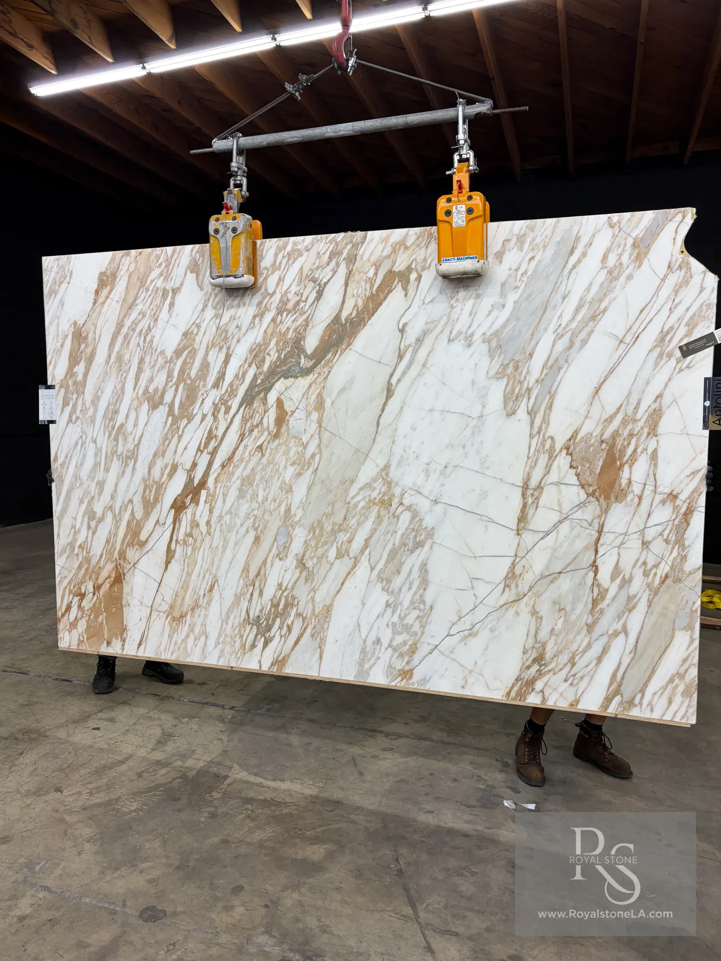 2cm Antolini Calacatta Monet Oro Classic EE505 honed marble slab, 78 by 121 inches, warm gold and taupe movement across a bright white field, at the Royal Stone yard in Los Angeles