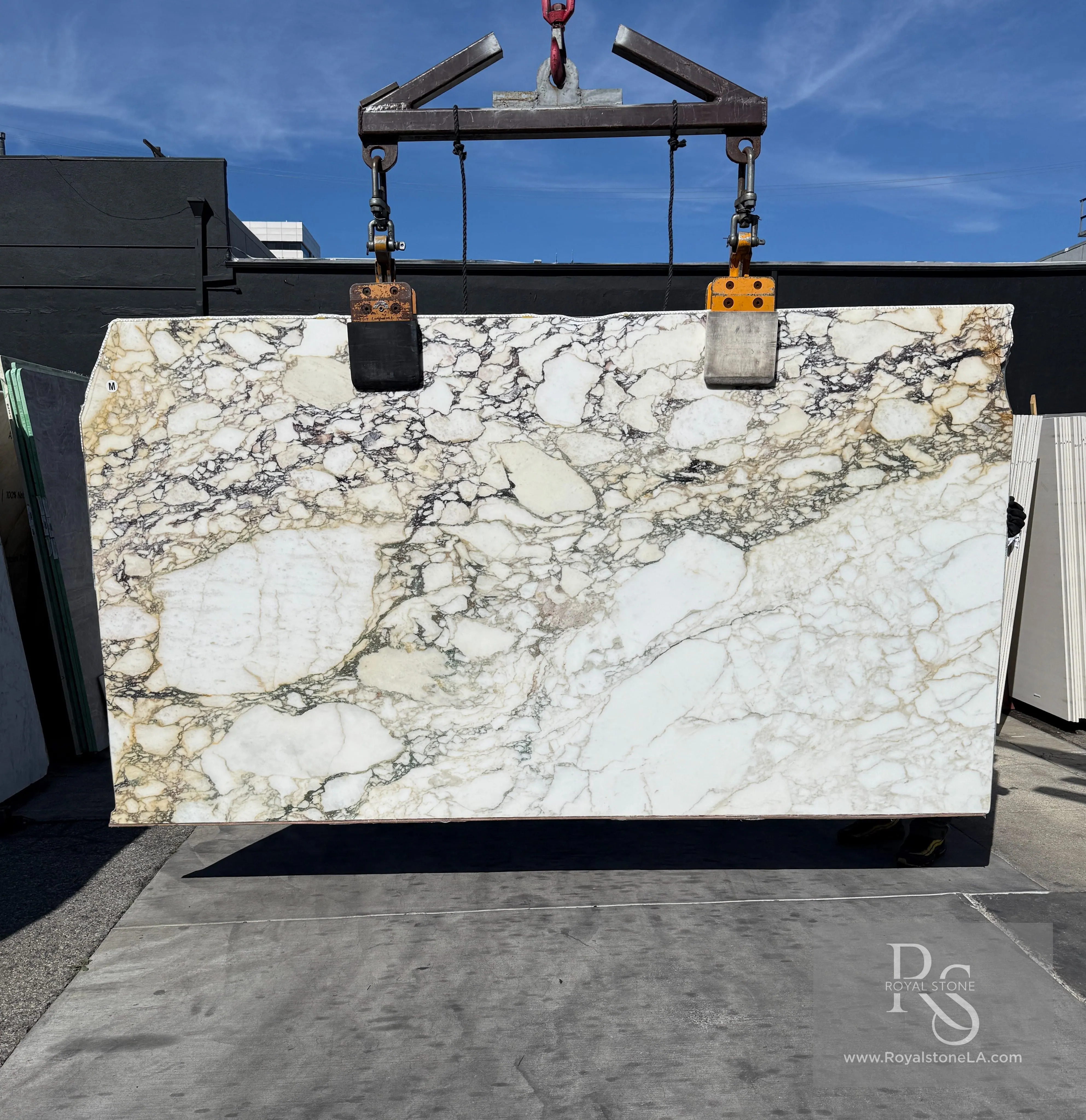 Calacatta Oro Gold Monet honed marble slab at Royal Stone, cream field with warm gold and gray painterly veining