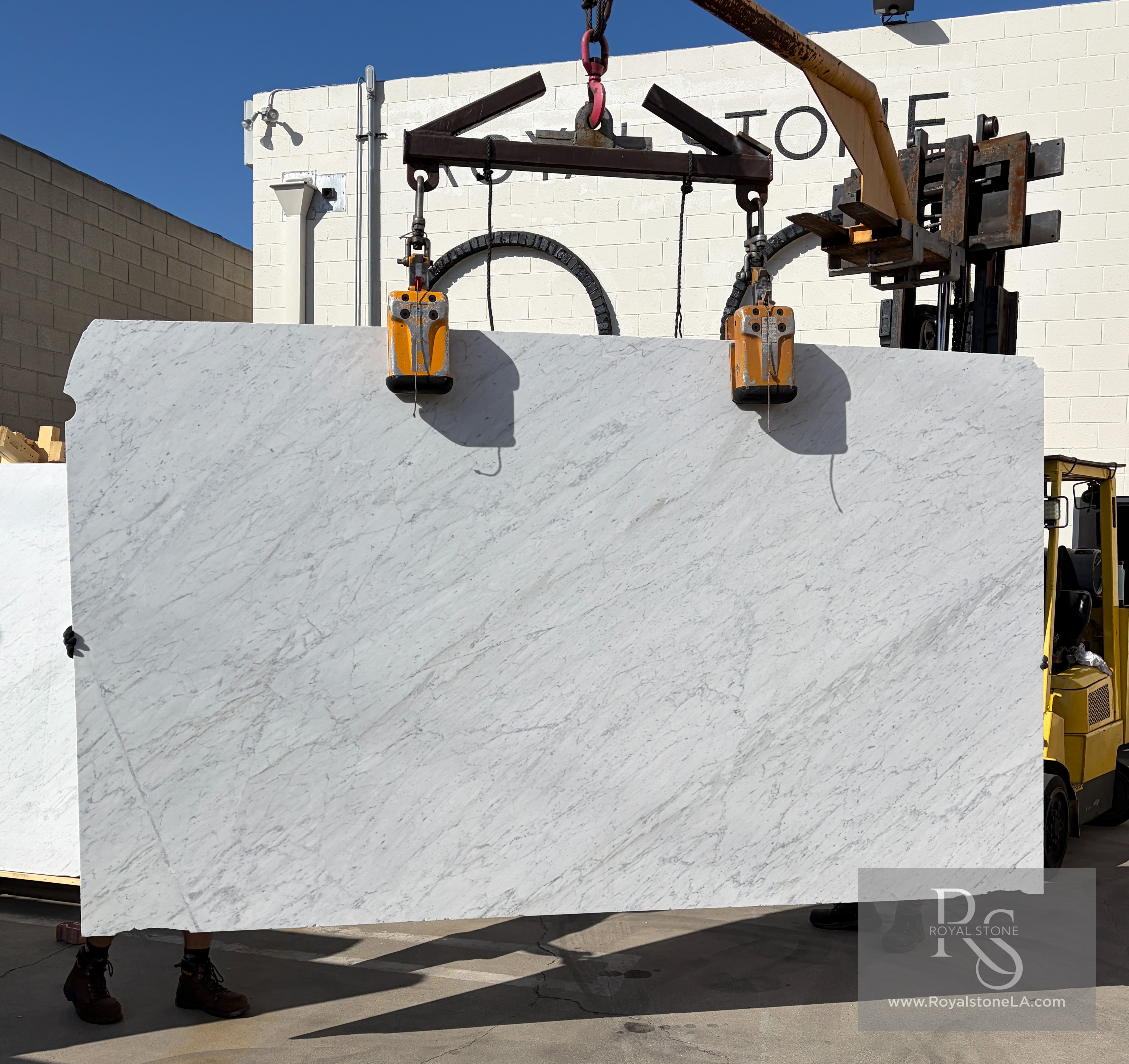 2cm Carrara White Select Petris honed marble slab, 75 by 129 inches, lifted on vacuum suction cups at the Royal Stone Los Angeles yard