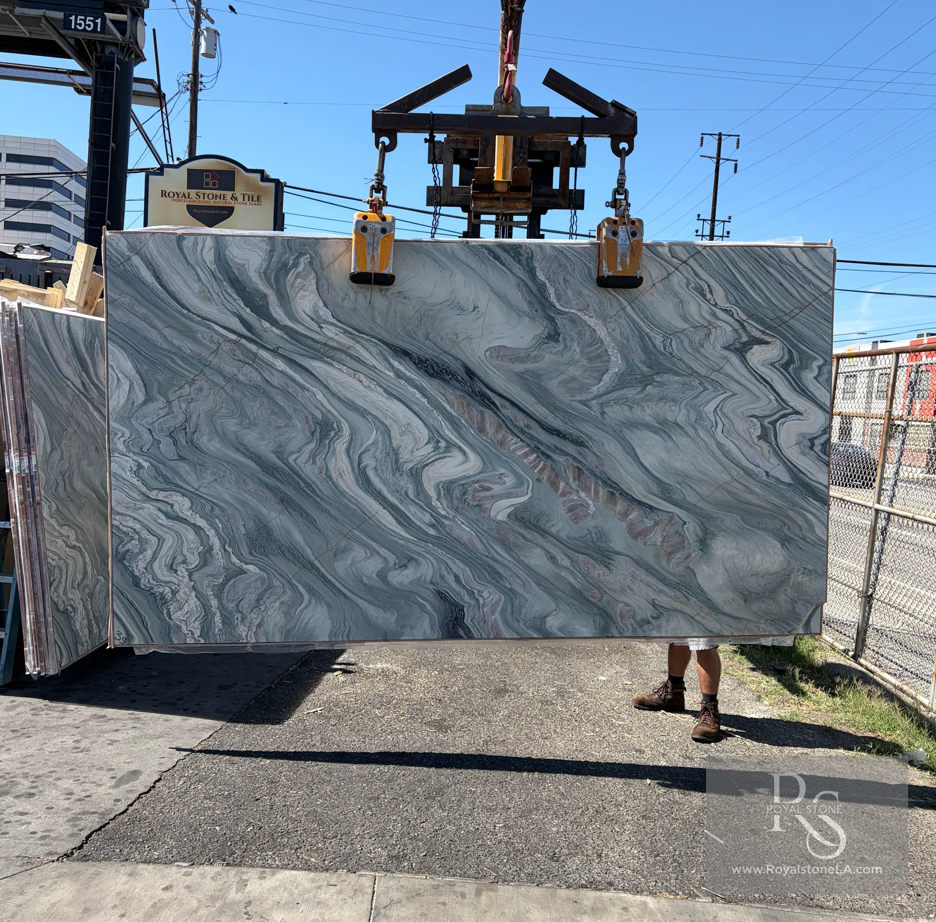2cm Cipollino Verde Select Bassi 8707 honed marble slab, 73 by 135 inches, with layered gray-green, white, and charcoal movement, lifted by crane at Royal Stone in Los Angeles