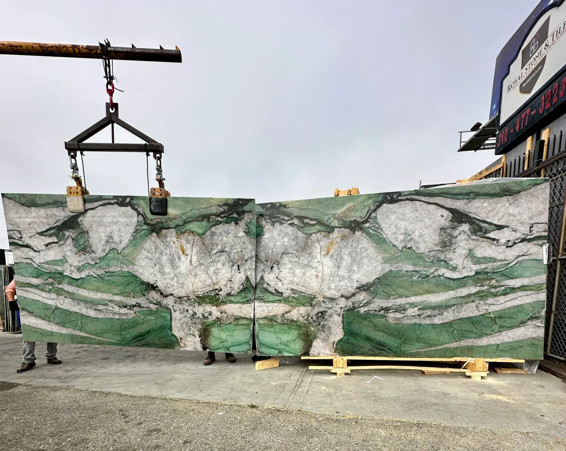 Bookmatched pair of Antolini Cristallo Tiffany Jade Patagonia quartzite slabs at Royal Stone, jade-green field mirrored across the seam with white crystal mountain-range composition, polished finish