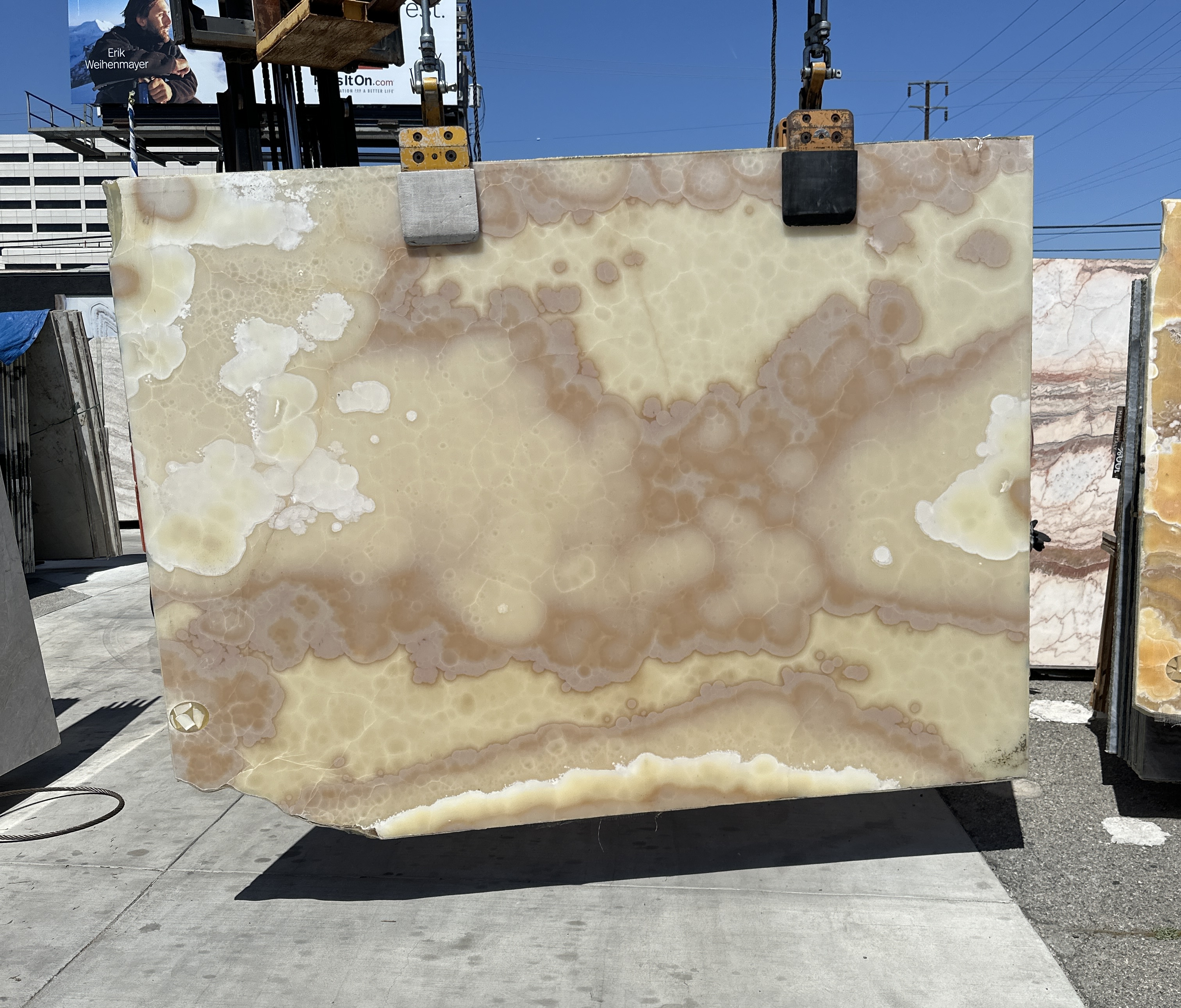 Honey Onyx cross-cut slab polished at 102 by 69 inches at Royal Stone Los Angeles, translucent honey body with crystalline cloud-like pools