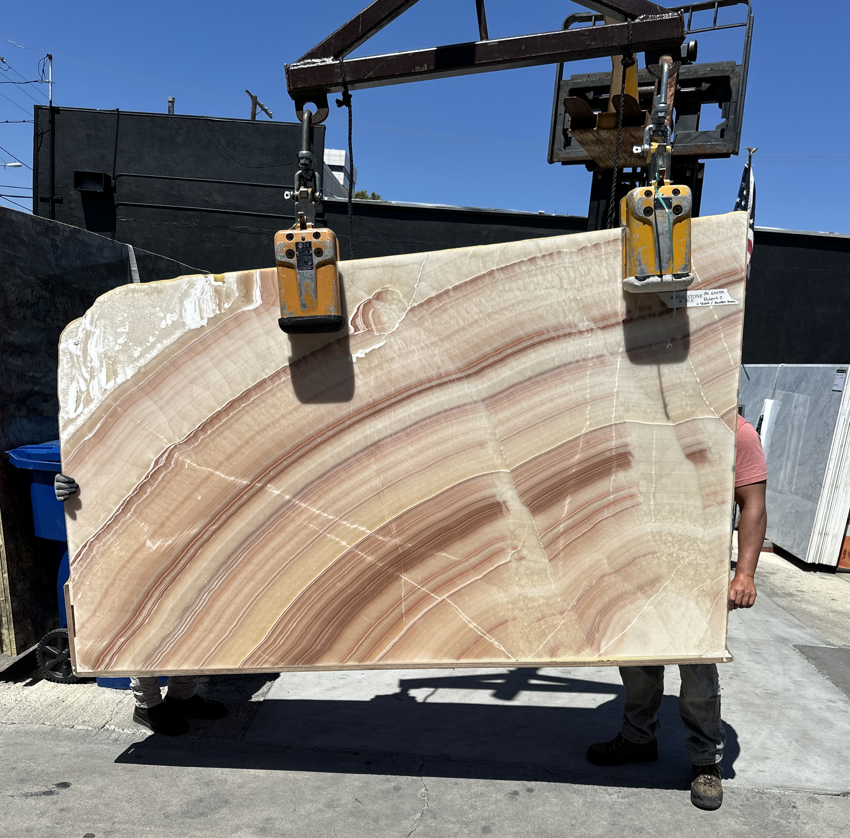 Honey Onyx wave-cut slab polished at 87 by 54 inches at Royal Stone Los Angeles, translucent honey and rose body with broad diagonal banding