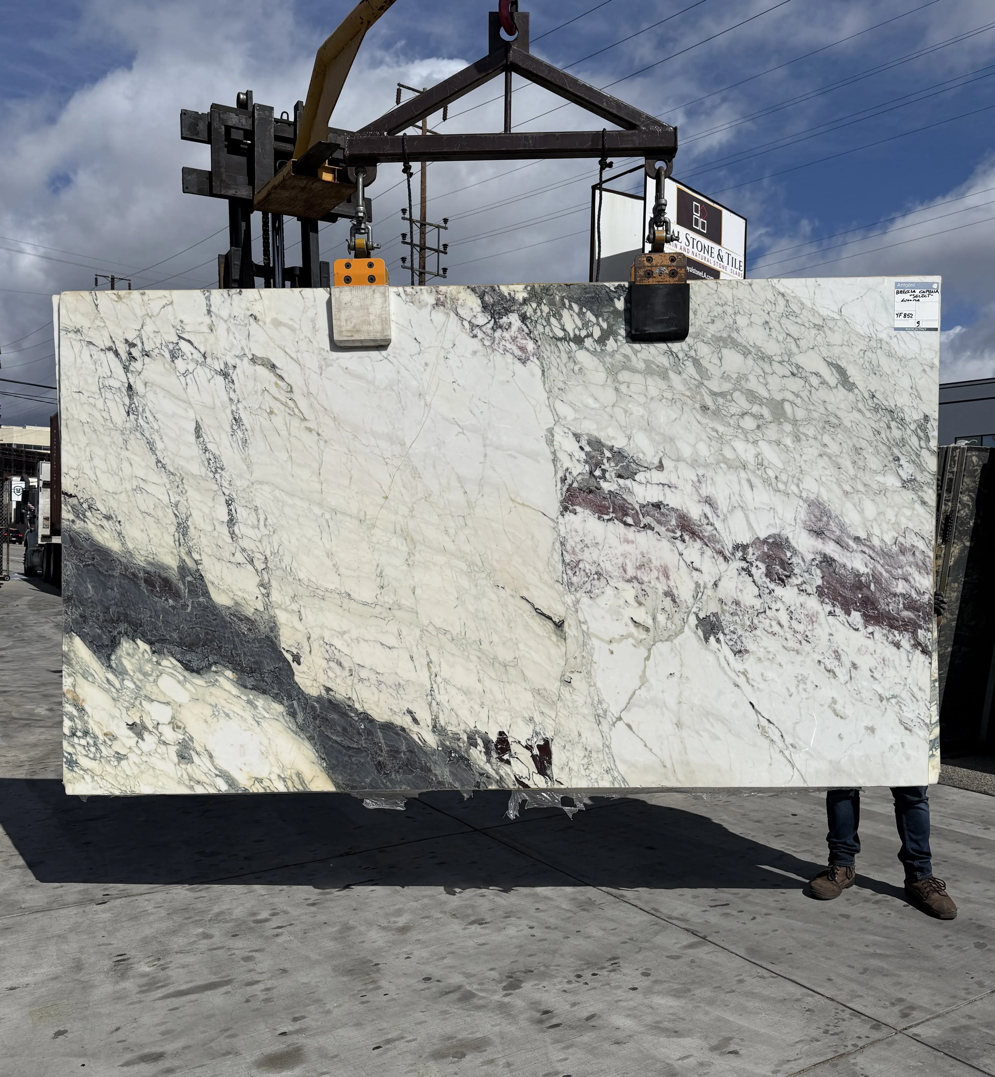 Rare brecciated marble slabs at Royal Stone, green and gold against ivory fragments