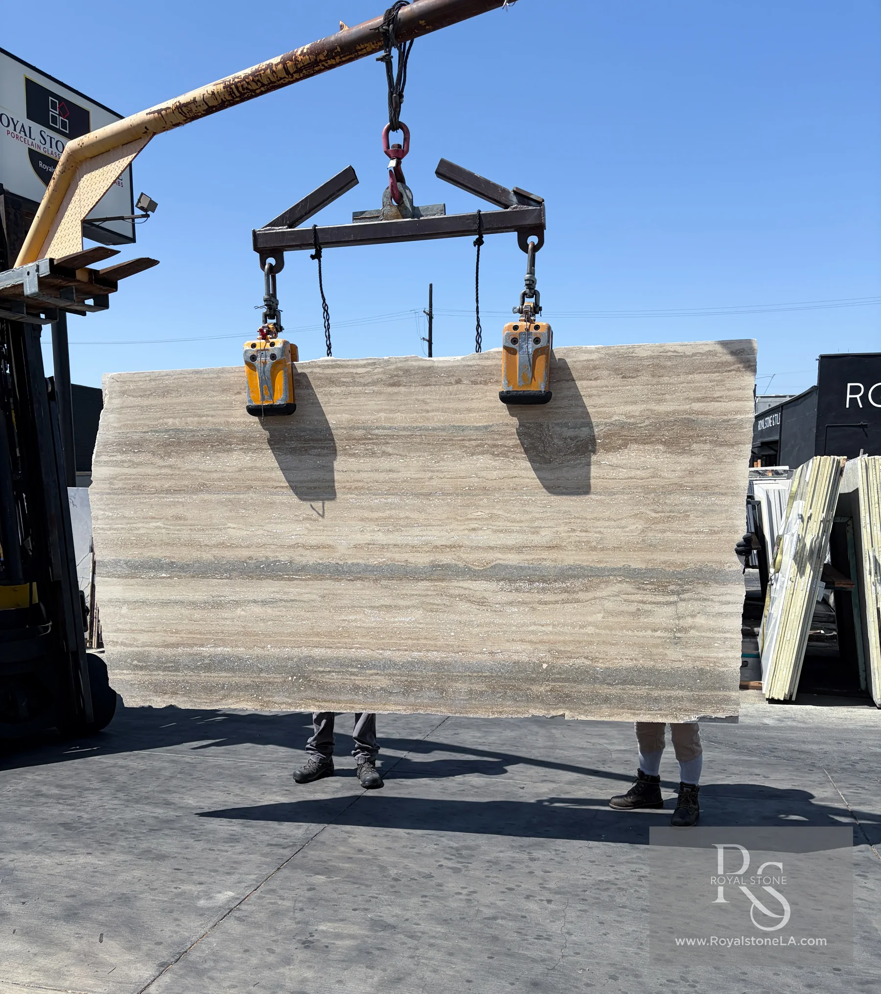 New 32-slab arrival of 2cm Italian Silver Travertine, vein cut, honed and filled, lifted by crane at Royal Stone Los Angeles, 58 by 106 inches