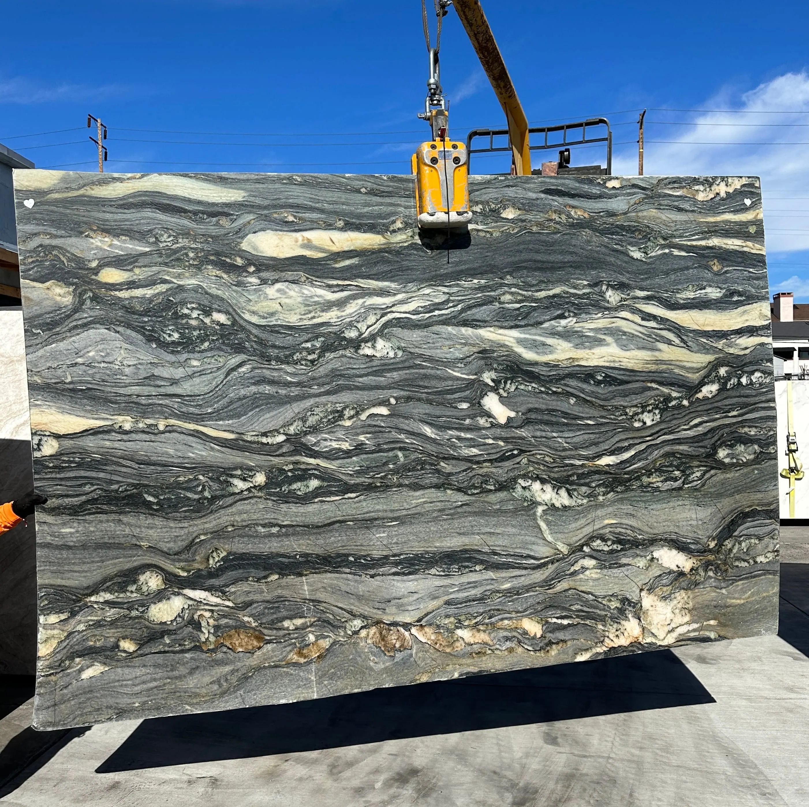 Paolo Blue Di Caravaggio Fusion quartzite slab in a leather-texture finish, near-black field with steel blue, ivory, and warm gold horizontal veining