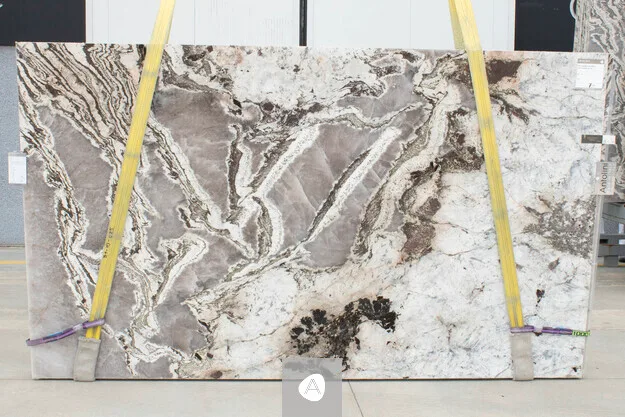 Antolini Patagonia Bianco quartzite slab with cream-white field and dramatic grey-brown veining, polished finish