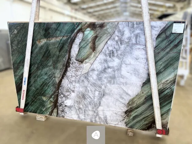 Antolini Patagonia Green quartzite slab with deep emerald-green flanks framing a translucent white-grey core, polished finish