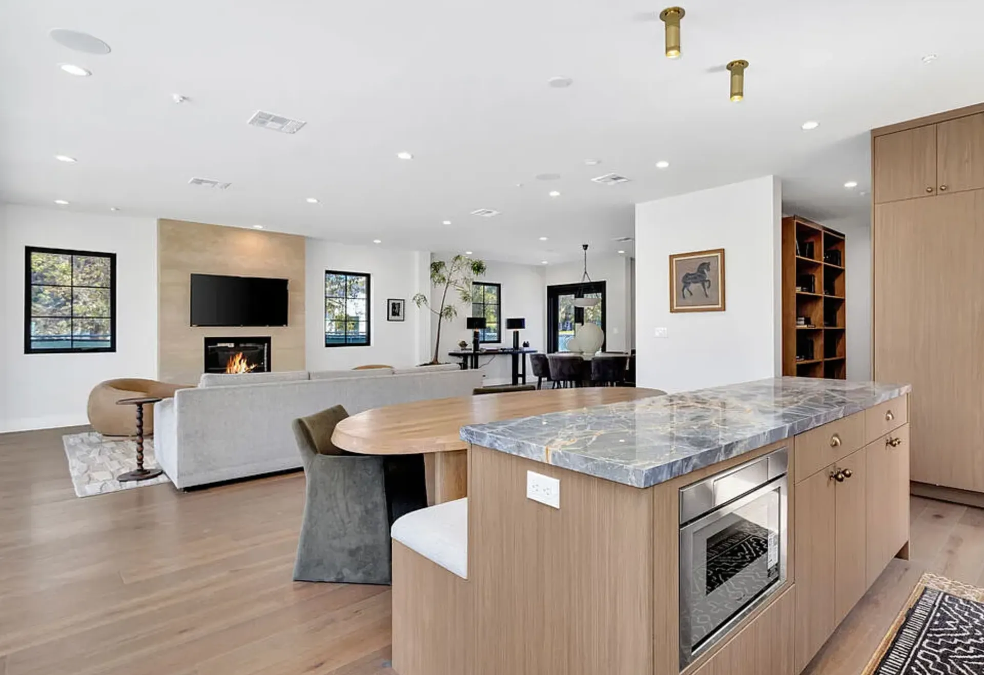 Portoro Gold Tempest polished marble across the kitchen island in the open-plan kitchen and living space at 8671 Clifton Way, Beverly Hills