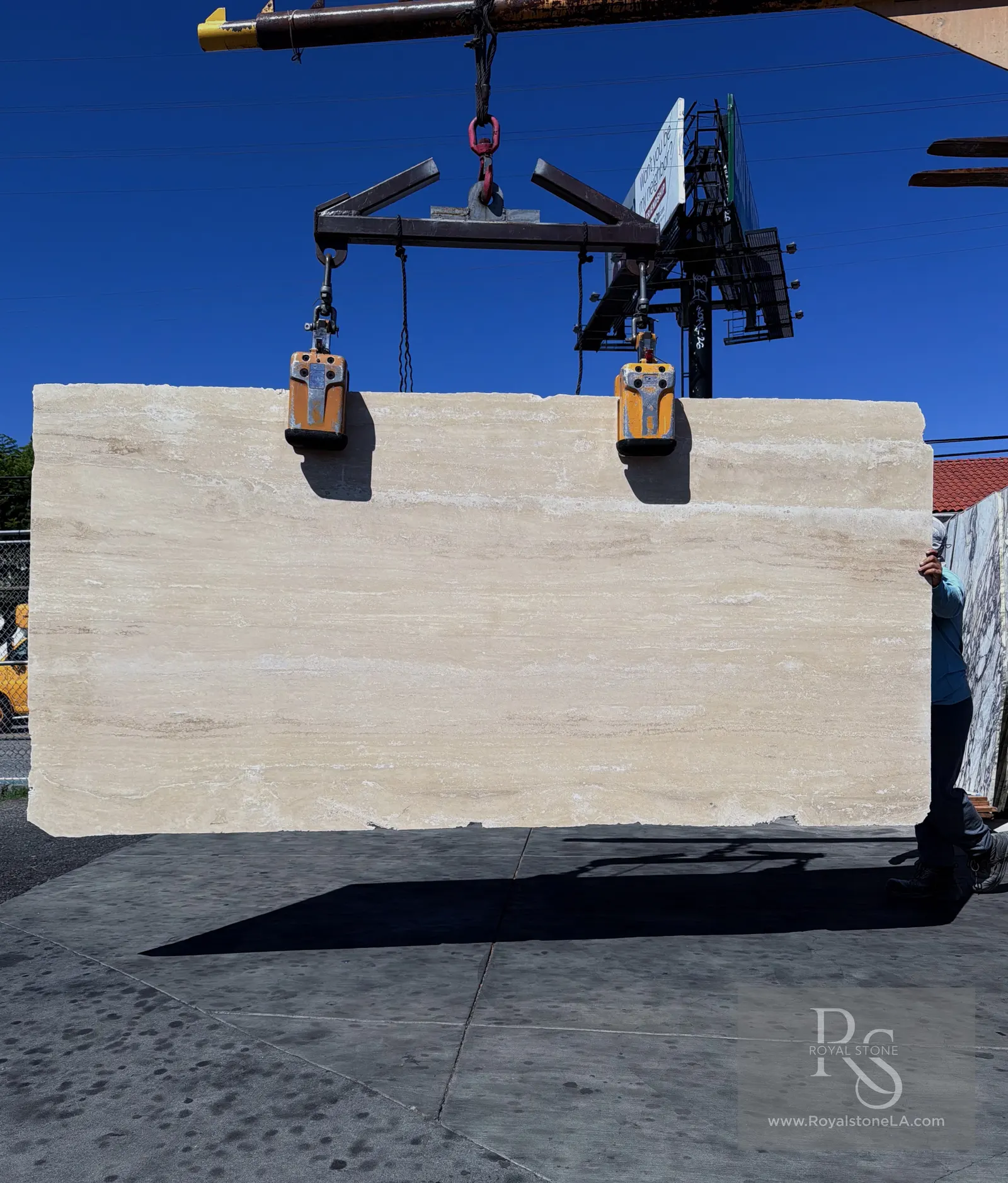 2cm Roman Italian Travertine slab, vein cut, filled and honed, 63 by 123 inches, lifted by overhead crane at Royal Stone Los Angeles