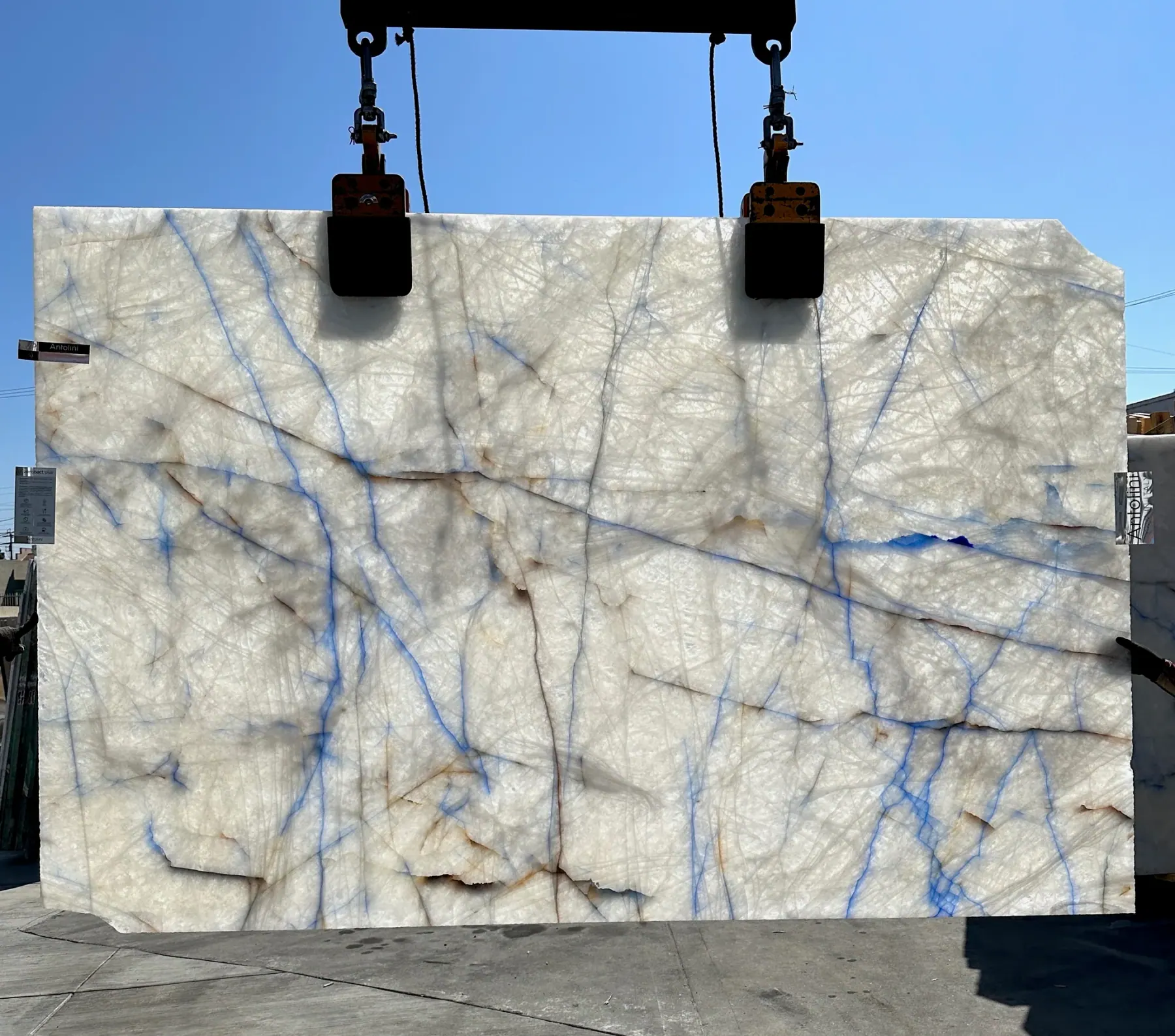 Antolini Cristallo Cobalt Blue Zaffiro slab backlit by the sun, cobalt blue veining darkening into a glowing crystalline white field