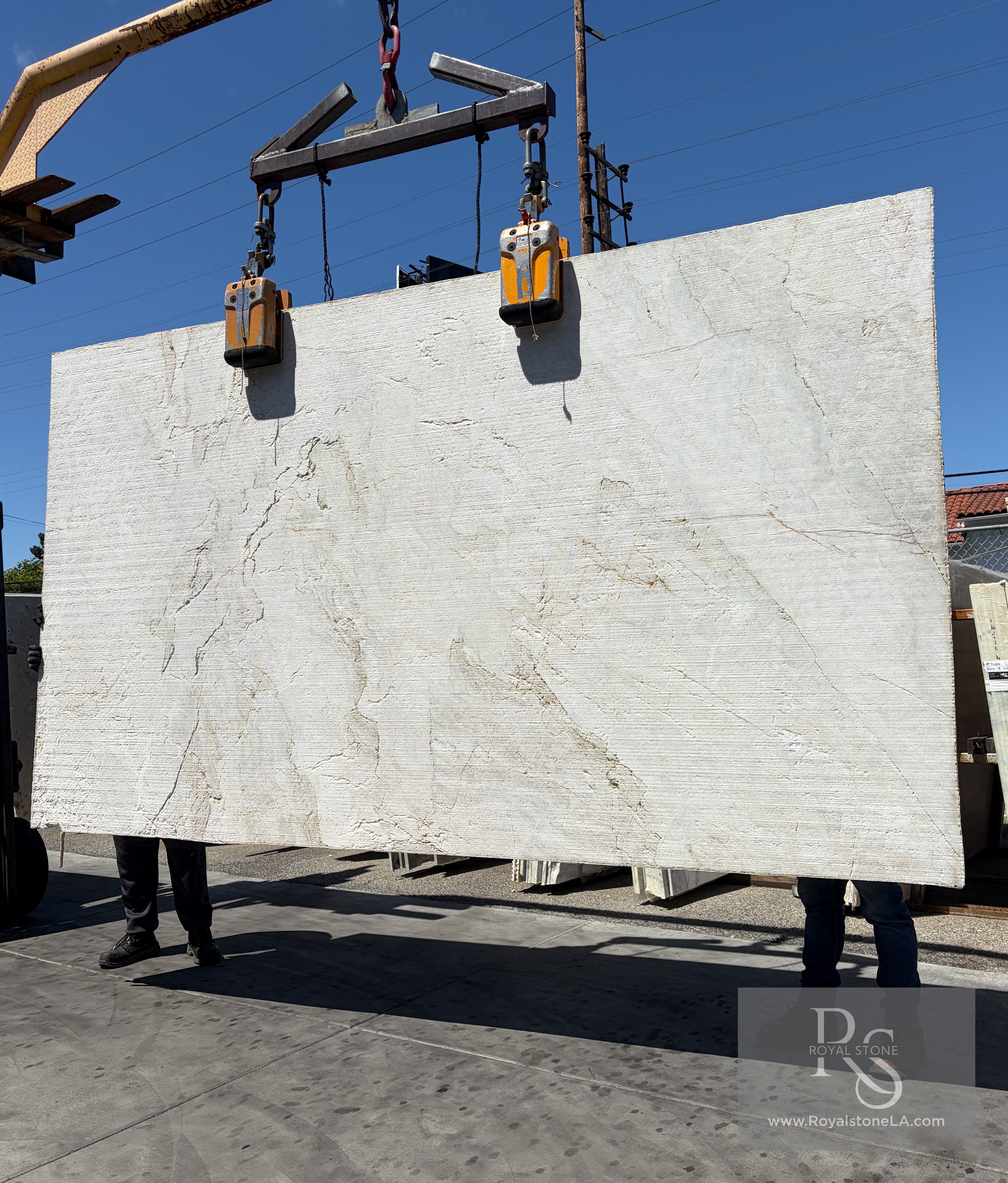 Antolini Taj Mahal quartzite slab with Stratos Rock Texture finish on the crane, soft ivory field with horizontal brushed banding, 78 by 137 inches