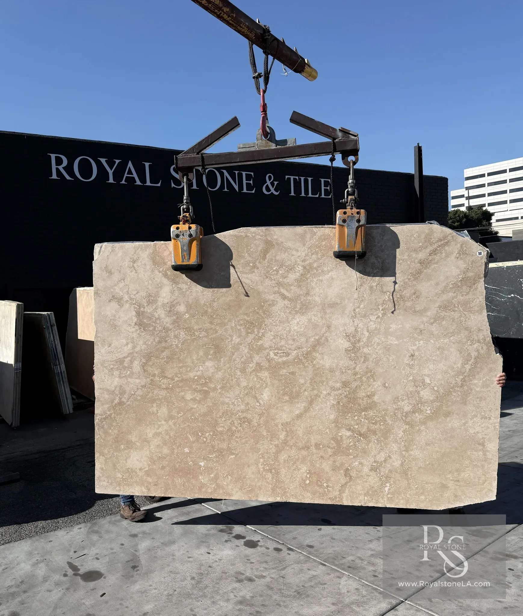2cm Italian travertine cross cut filled and honed slab at Royal Stone Los Angeles, warm cream and oat field with soft cloud-like cross-cut passages and dispersed rust mineral pockets, 72 by 110 inches