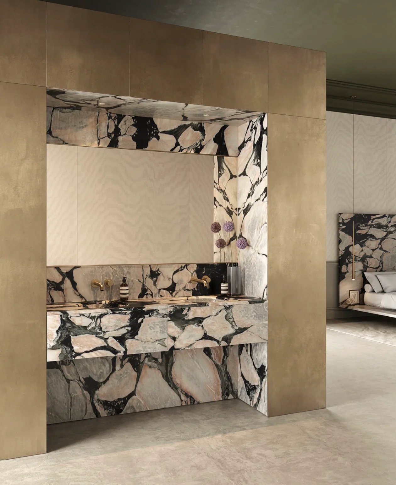 Viola Antico Paonazzo marble installed in a primary bathroom — ivory and rose breccia with black serpentine veining run as a back wall, integrated trough sink, vanity face, and horizontal soffit, framed by brushed bronze metal paneling, with wall-mounted bronze tapware and an open archway extending the same marble onto a headboard wall in the bedroom beyond