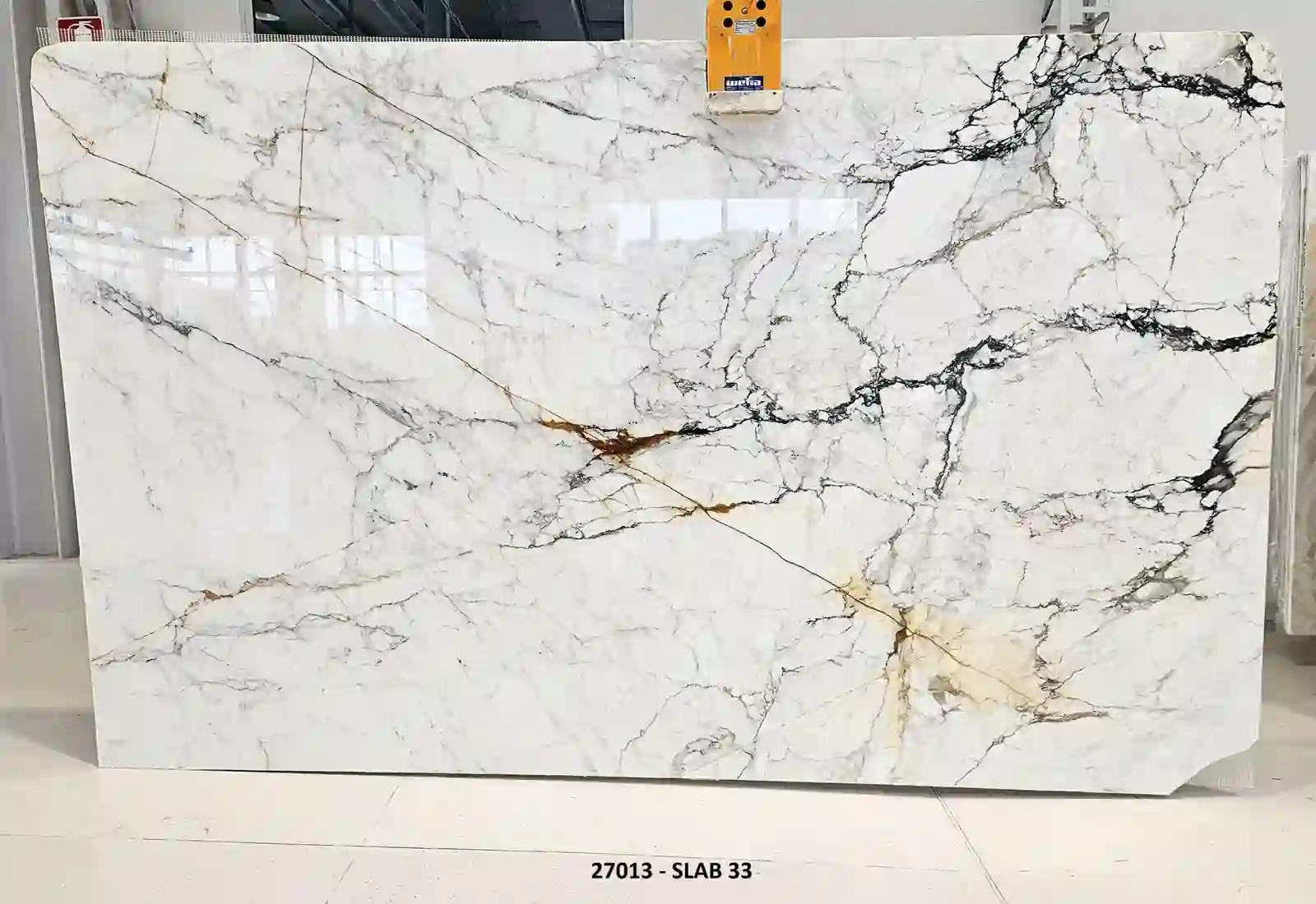 Calacatta Fabricotti Paonazzo polished marble slab from lot 27013, with a white field, gray-black veining, and gold-rust accents