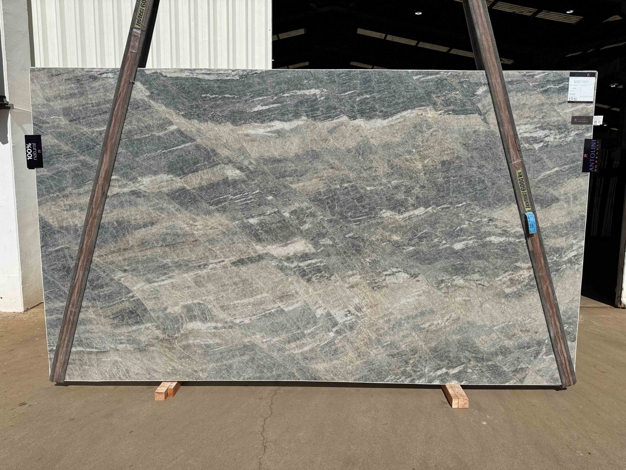 Antolini Cielo Select quartzite slab from Brazilian Block AO723, sweeping blue-gray and sand movement in a matt finish, photographed at the stone yard
