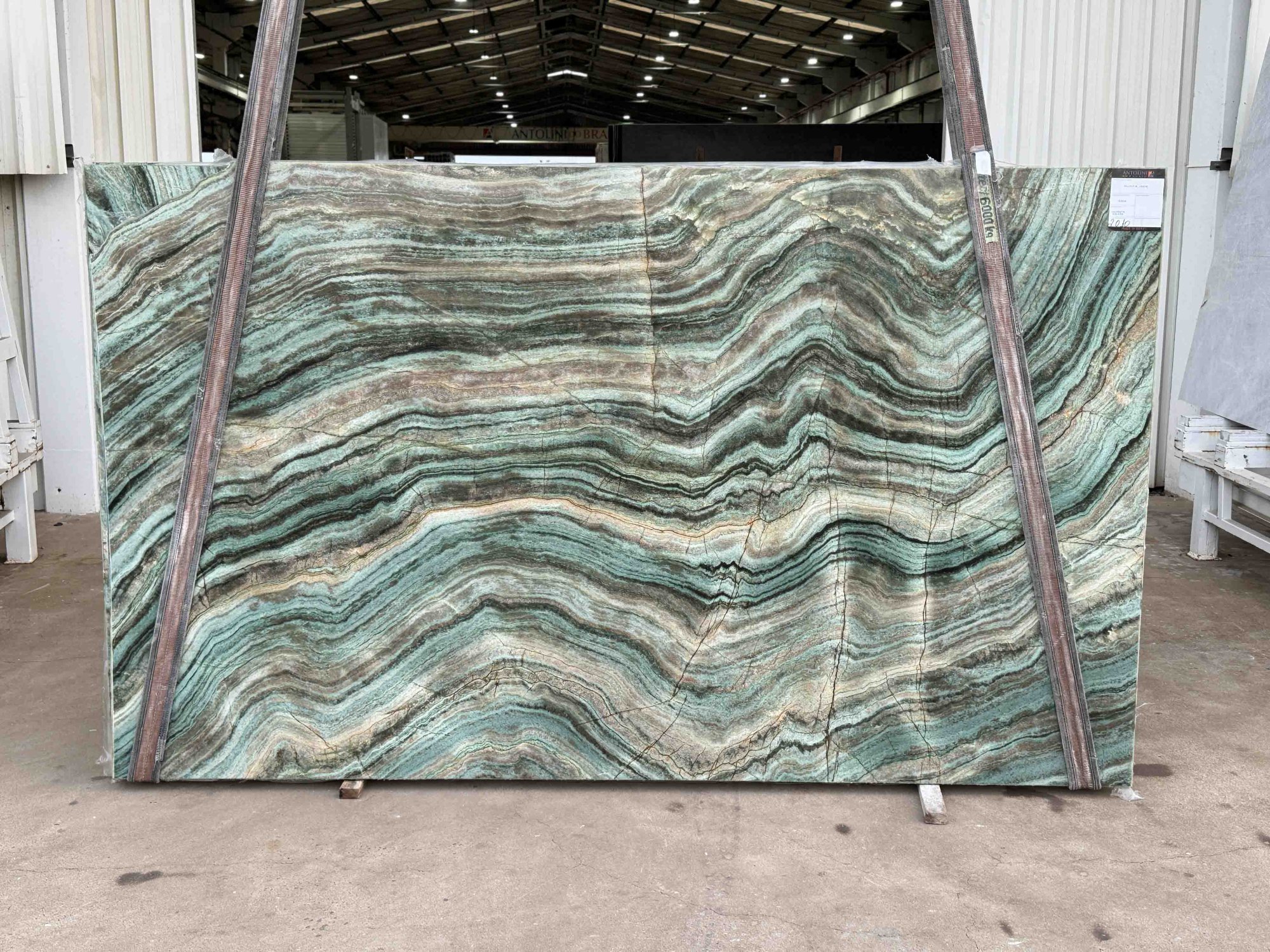 Antolini Fuxita Jade quartzite slab from Brazilian Block EG439, chapas 53 through 58, with wavy turquoise, jade, and bronze banding, photographed at the stone yard