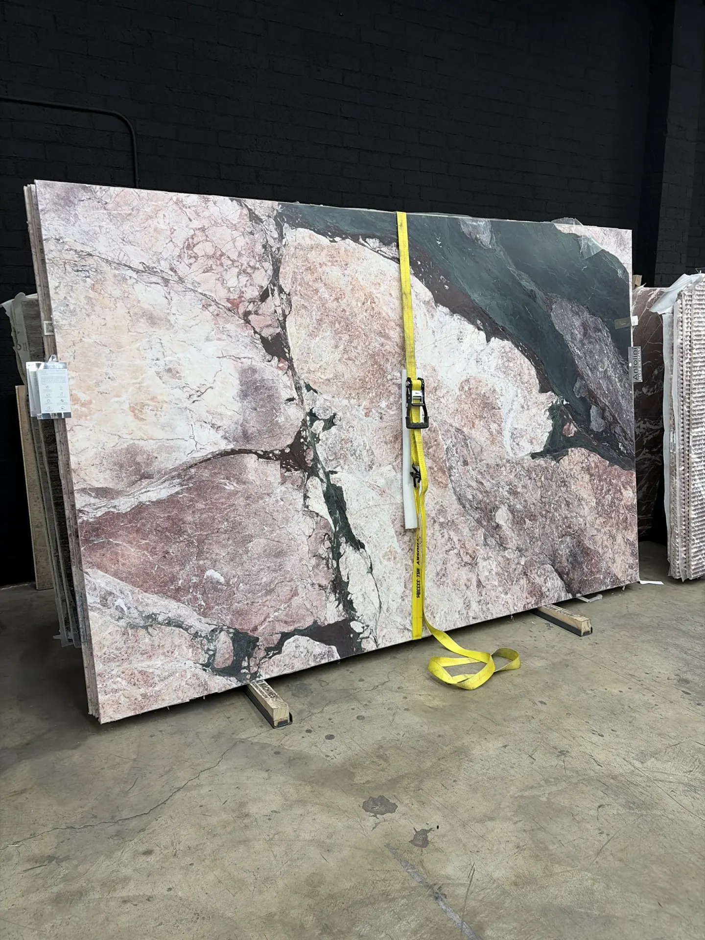 2cm Antolini Opera D’Arte Select marble slab EE092 standing in the Royal Stone yard bundles, showing the full dramatic movement across the honed field