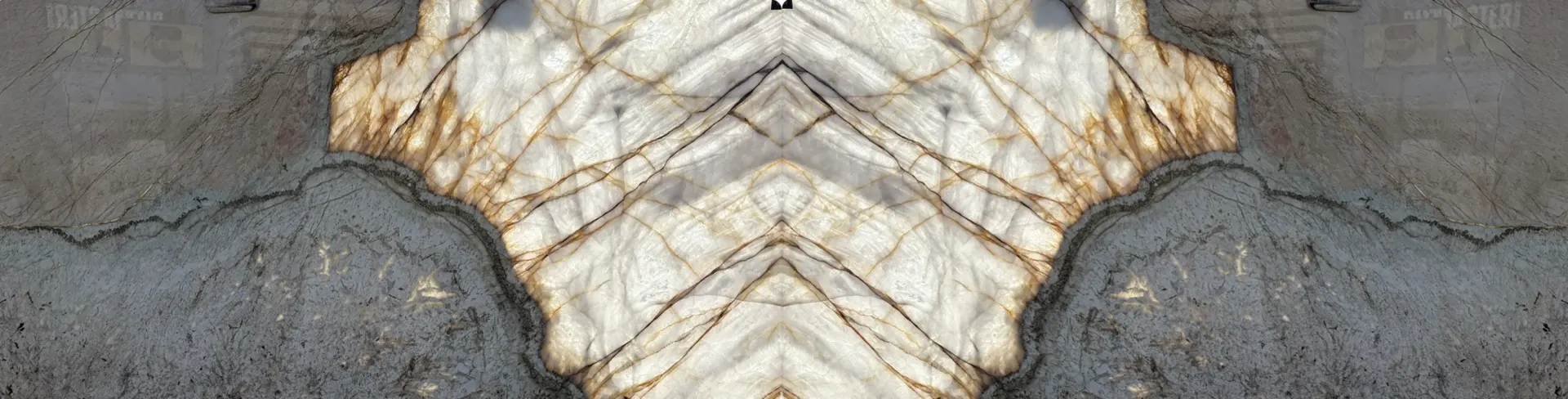 Bookmatched Antolini Patagonia Vitrum ZZ458 quartzite slabs illuminated from behind, showing a symmetrical luminous crystal formation with amber veining and darker mineral edges