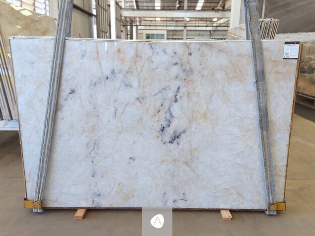 Antolini Cristallo Brut quartzite slab with crystalline white field and soft violet and gold veining, polished