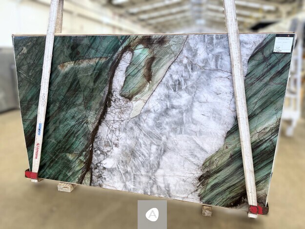 Antolini Patagonia Green quartzite slab with deep emerald-green flanks framing a translucent white-gray core, polished